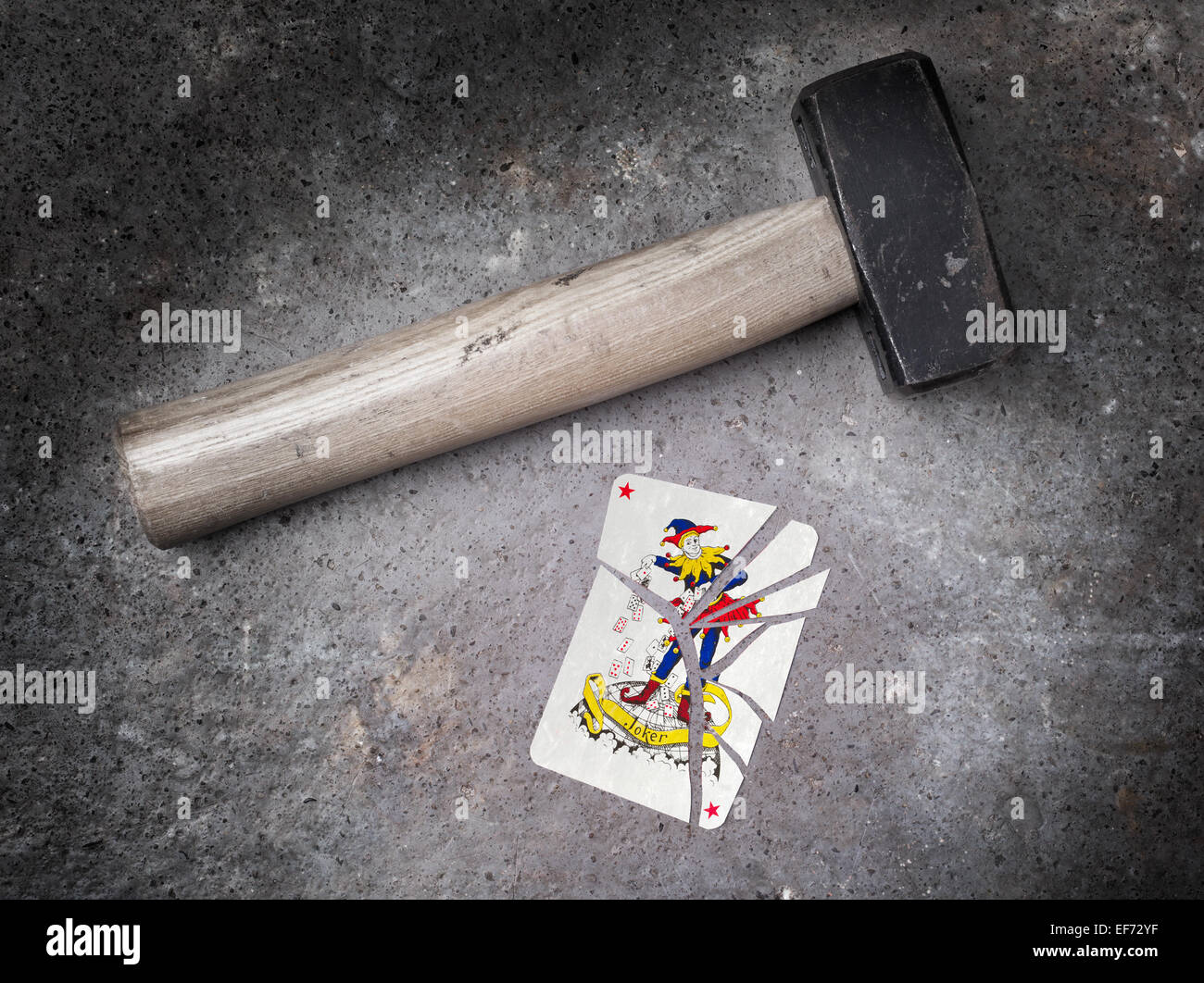 Hammer with a broken card, vintage look, joker Stock Photo Alamy