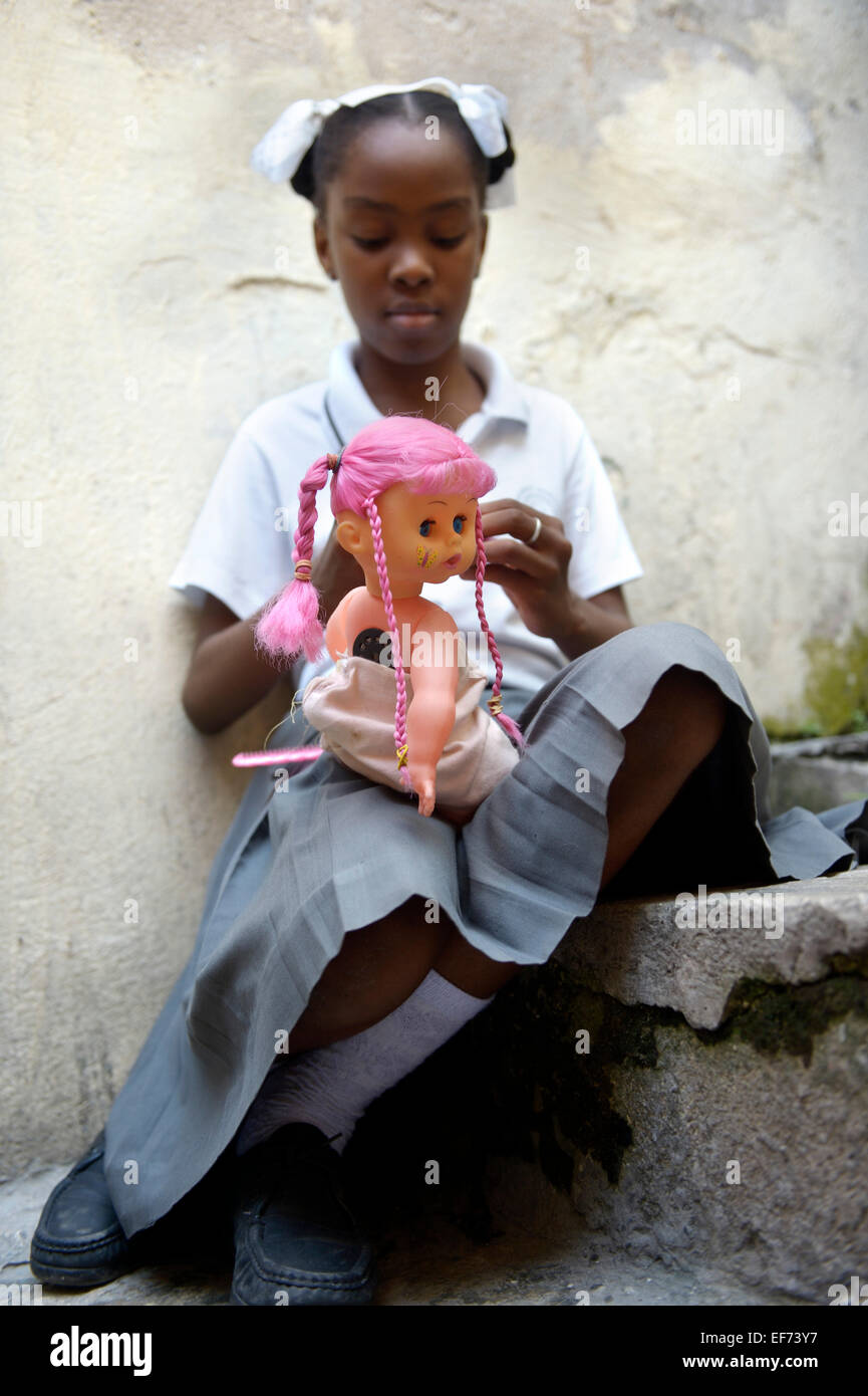 Girl, 10 years, with a doll, Carrefour, Port-au-Prince, Department Ouest, Haiti Stock Photo