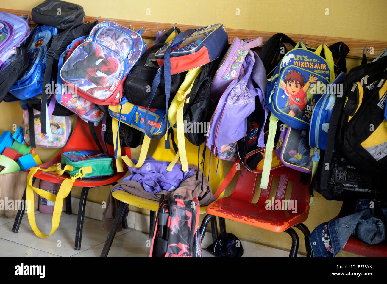 Kindergarten bags hanging on the wall, kindergarten, Basile Moreau primary school, Carrefour, Port-au-Prince, Ouest Department Stock Photo