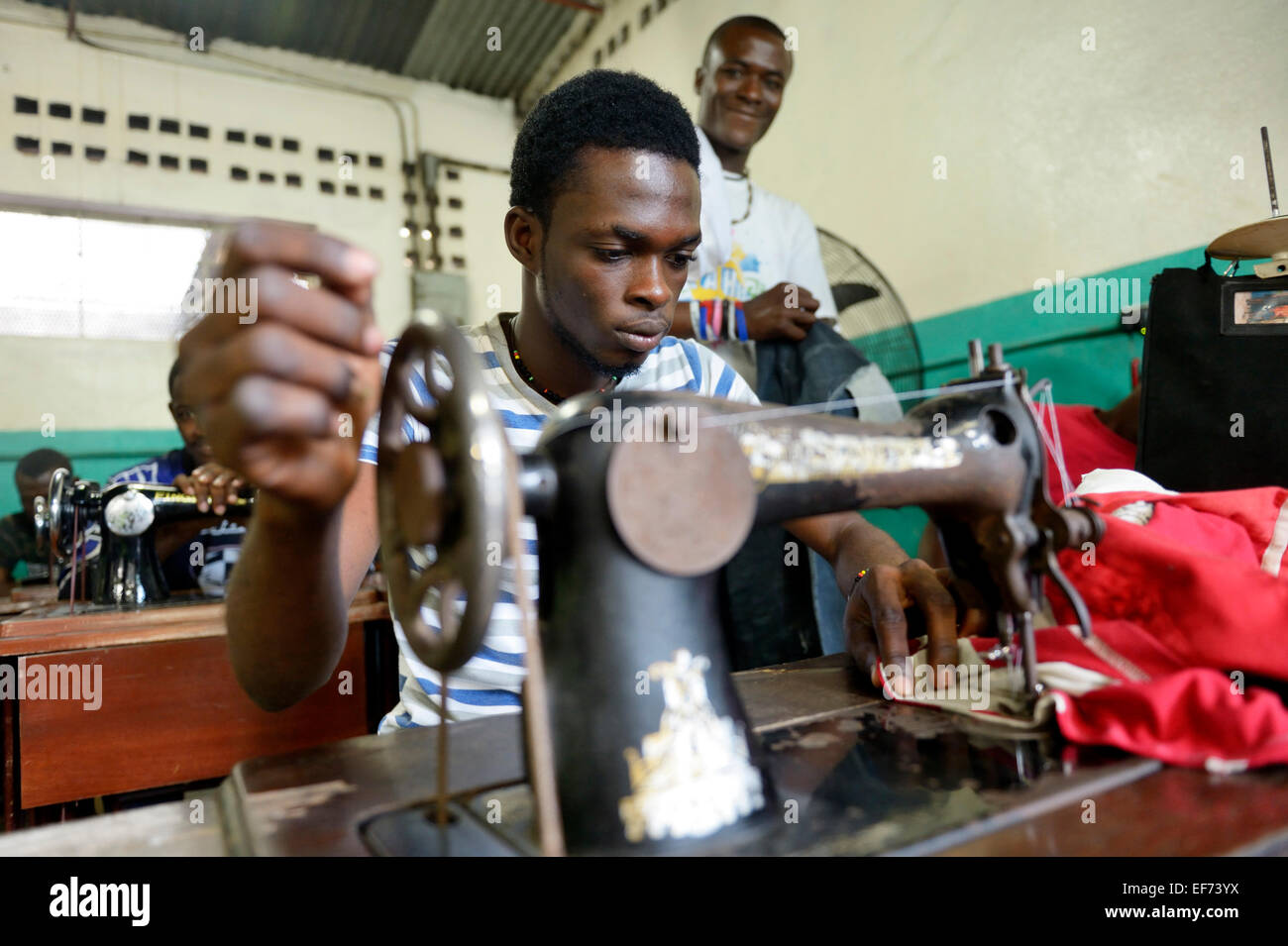 Young man working on a sewing machine learning tailoring crafts, tailoring school of the Salesian Missions Stock Photo
