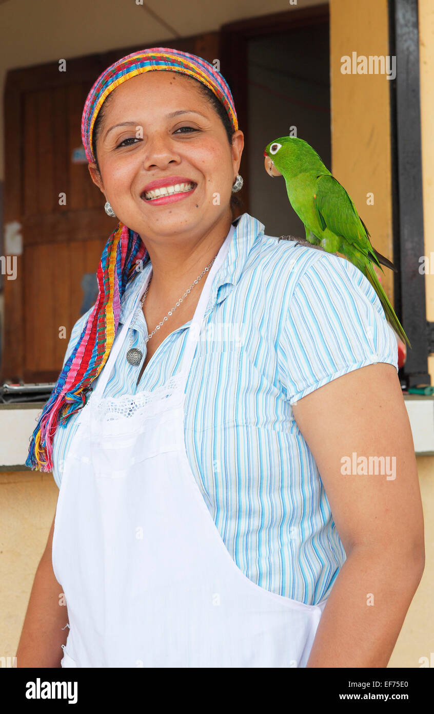 Woman with a parrot on her shoulder, San Carlos, Rio San Juan, Nicaragua Stock Photo
