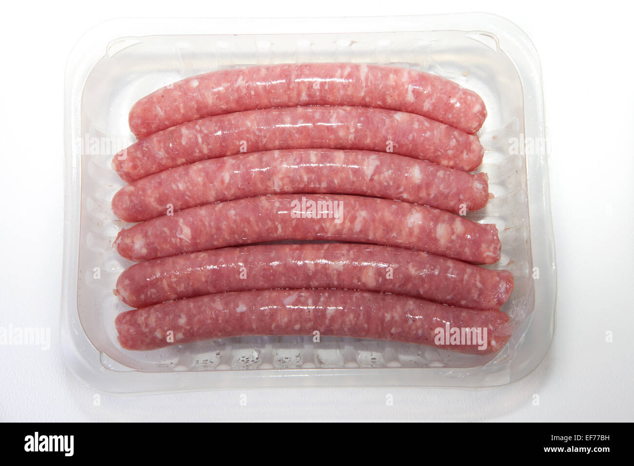 Spicy pork sausages on the package, isolated on white background Stock