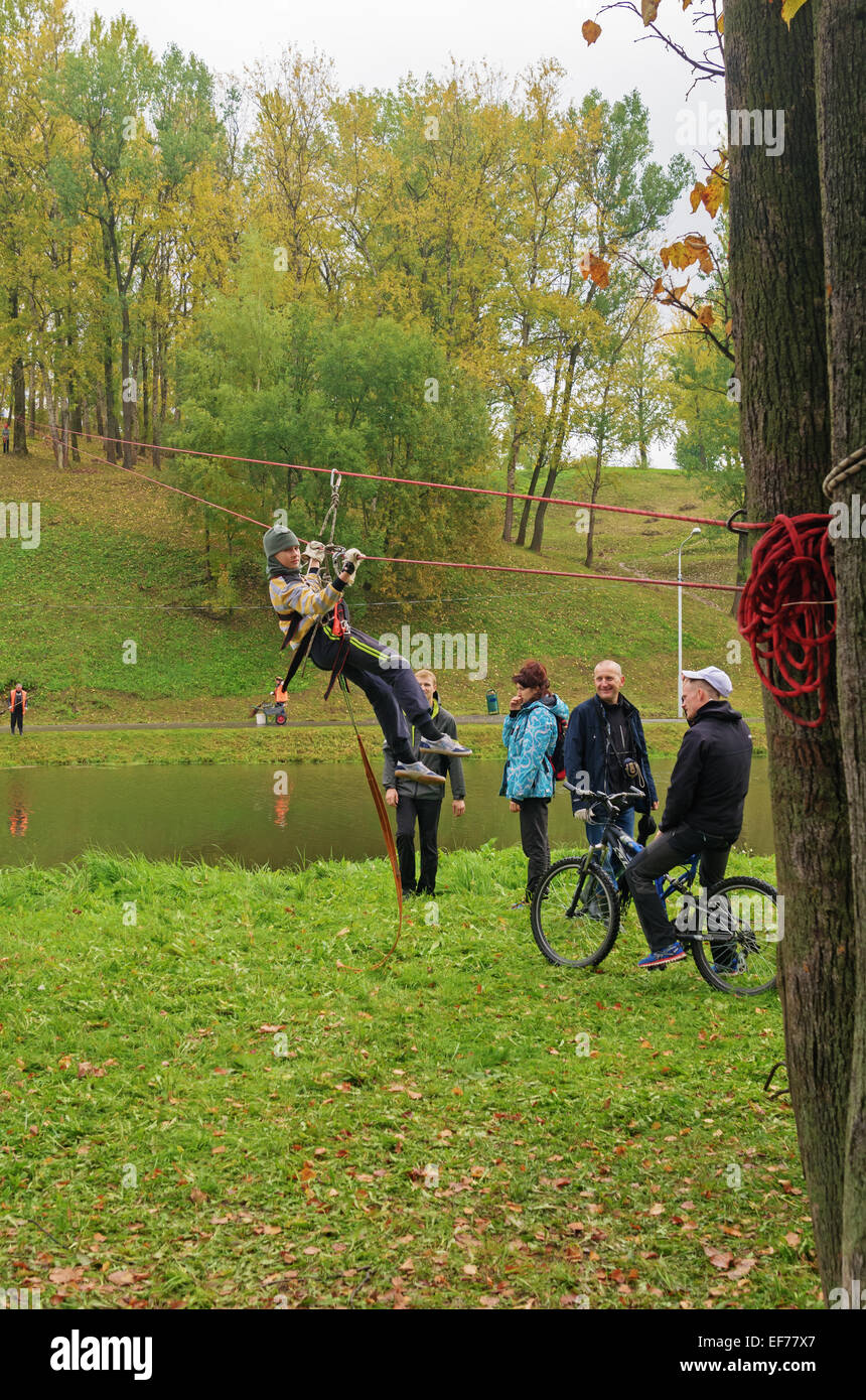 World Tourism Day - sport tourism competition in park on the river Vitba, Vitebsk, inclined crossing on ropes through the river. Stock Photo