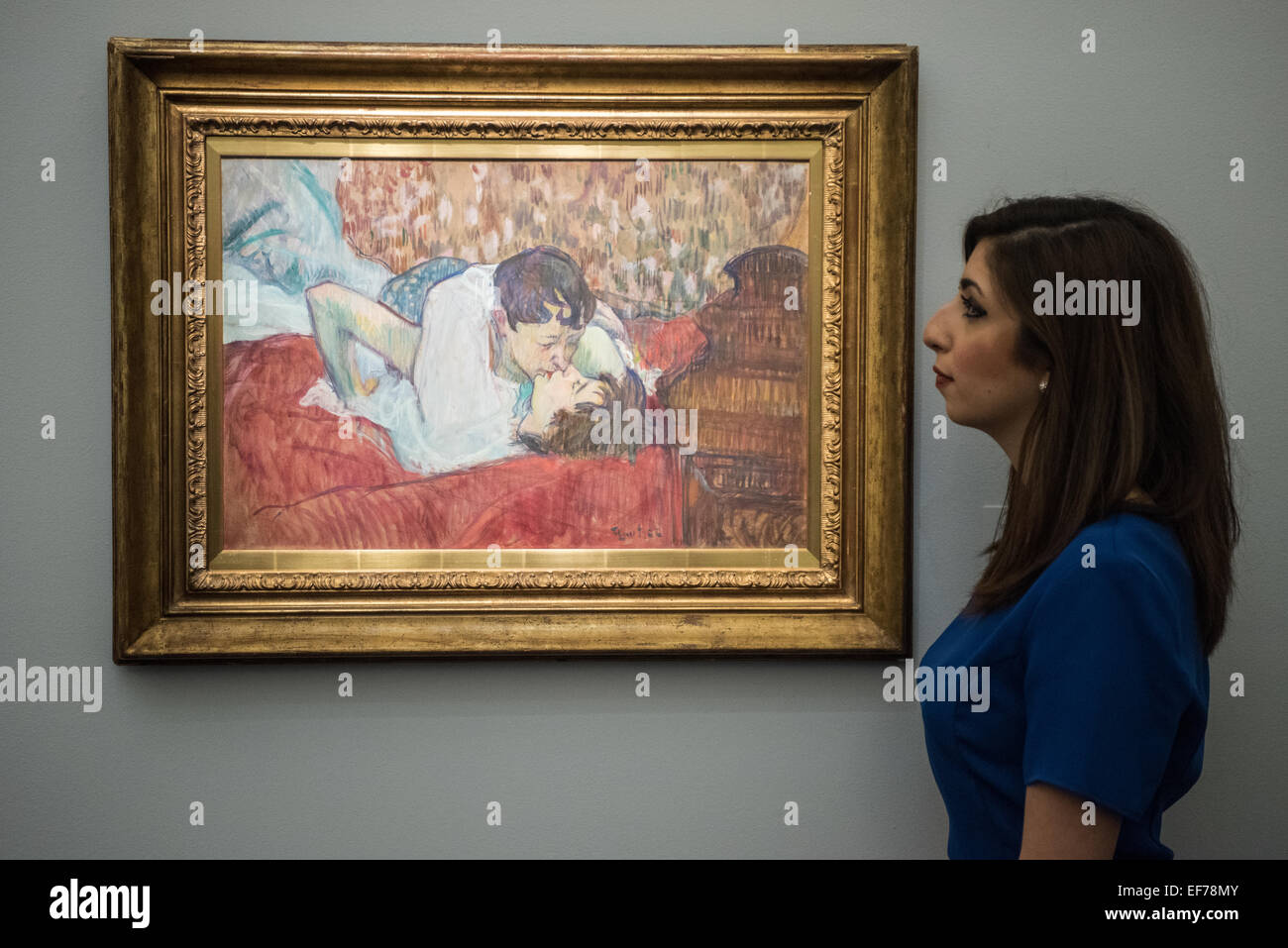 London, UK. 28th January, 2015. : a Sotheby's employee looks at Au lit: le  baiser (£9-12 million) by Henri de Toulouse-Lautrec during the press view  of the Impressionist & Modern, Surrealist and