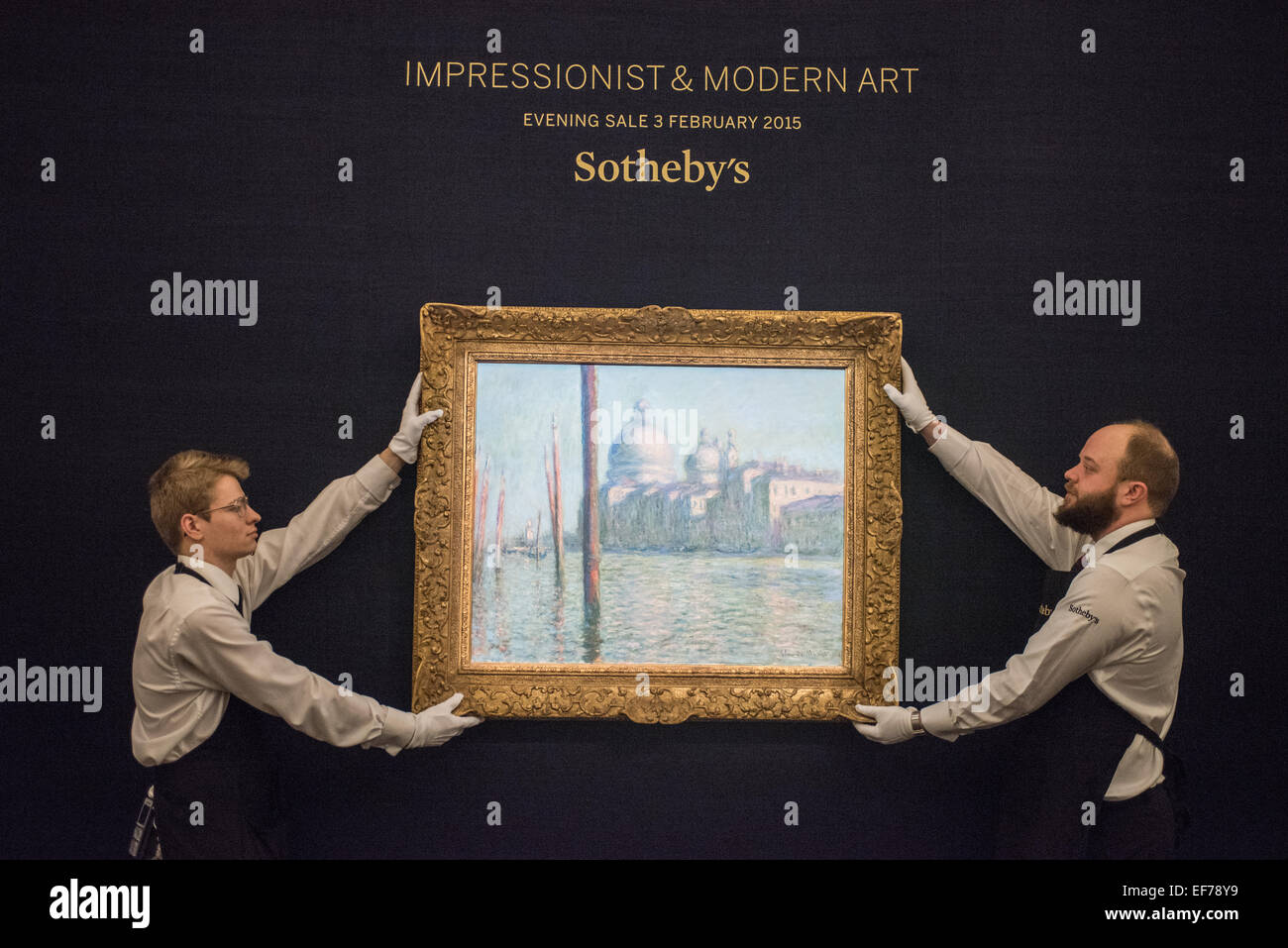 London, UK. 28th January, 2015. Sotheby’s employees hold ‘Le Grand Canal’ by Claude Monet (est. £20-30m) during the press view of the Impressionist & Modern, Surrealist and Contemporary Art sale together estimated at over £233 million Credit:  Piero Cruciatti/Alamy Live News Stock Photo