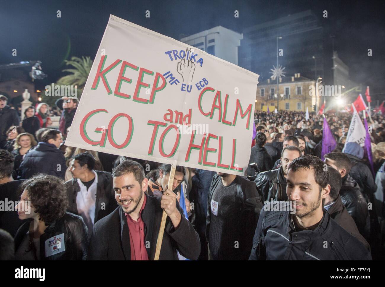 A Poster with the Slogan 'Troika- KEEP CALM AND GO TO HELL' is seen after Alexis Tsipras leader of the radical left main opposition party Syriza held his speech in front of the University after the Greece general elections in Athens, 25 January 2015. Greece's leftist, anti-austerity Syriza party and her leader Alexis Tsipras, has widened its lead at the top for the 25 January 2015 elections- riding a wave of anger over austerity measures imposed as a condition for an international bailout. Photo: Michael Kappeler/dpa Stock Photo