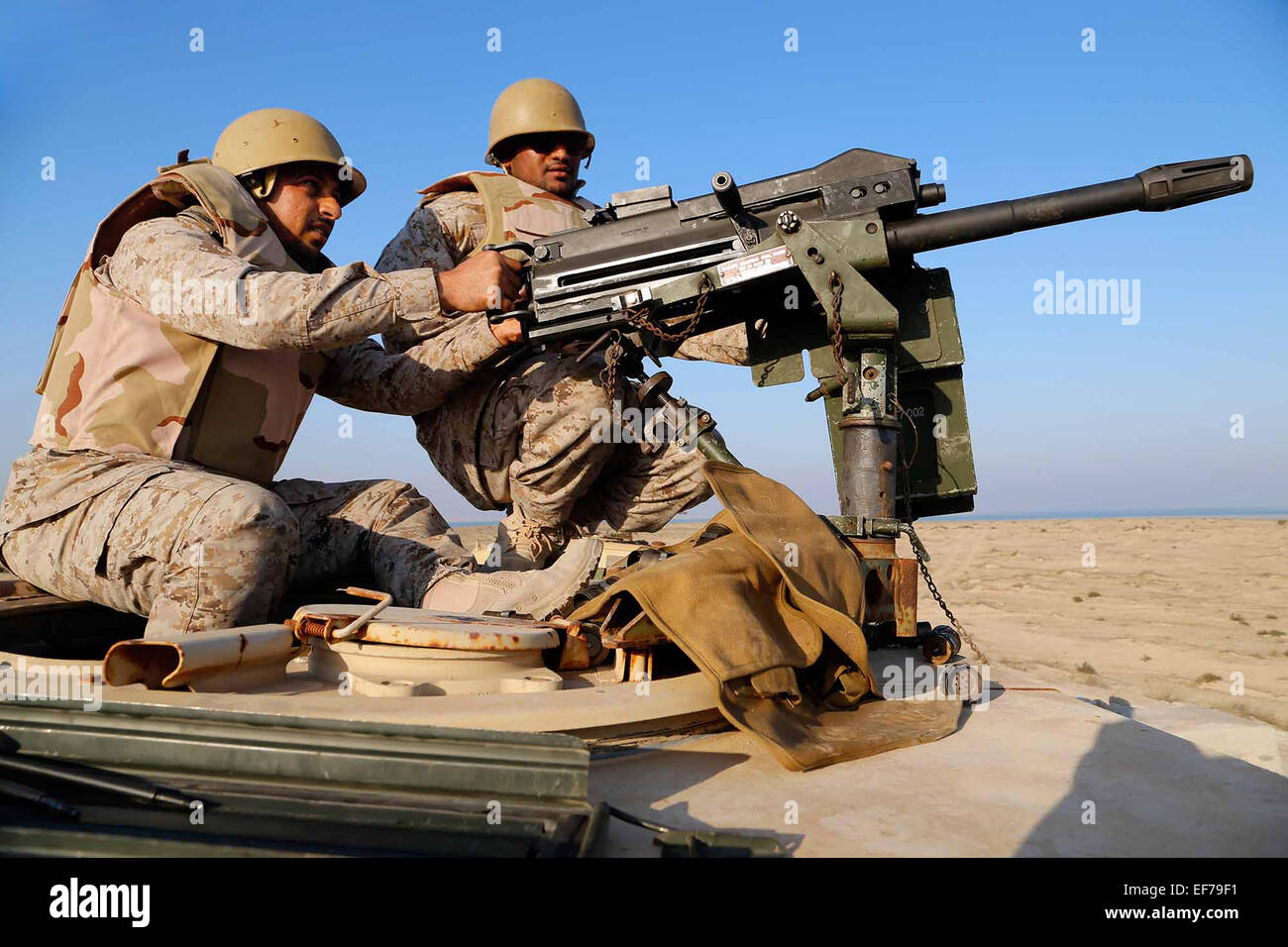 A Saudi Marine fires a Mk19 grenade launcher during a joint machine gun live fire exercise with U.S. Marines as part of exercise Red Reef December 11, 2014 in Ras Al Khair, Saudi Arabia. Stock Photo