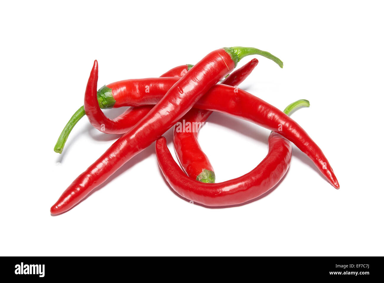 Stack of red hot chili peppers isolated on white Stock Photo - Alamy