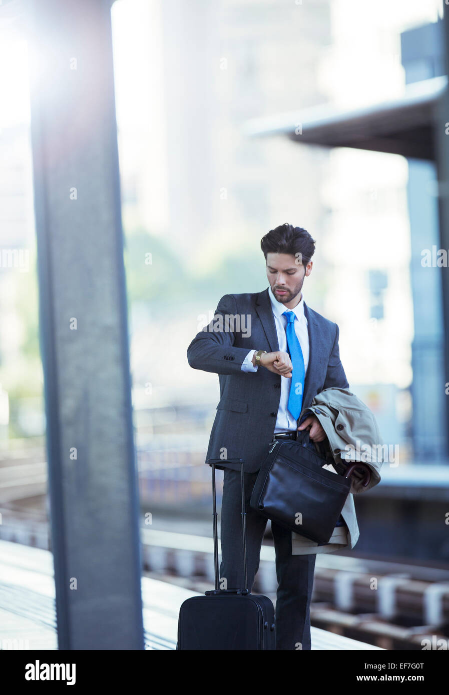 Businessman checking his watch in train station Stock Photo