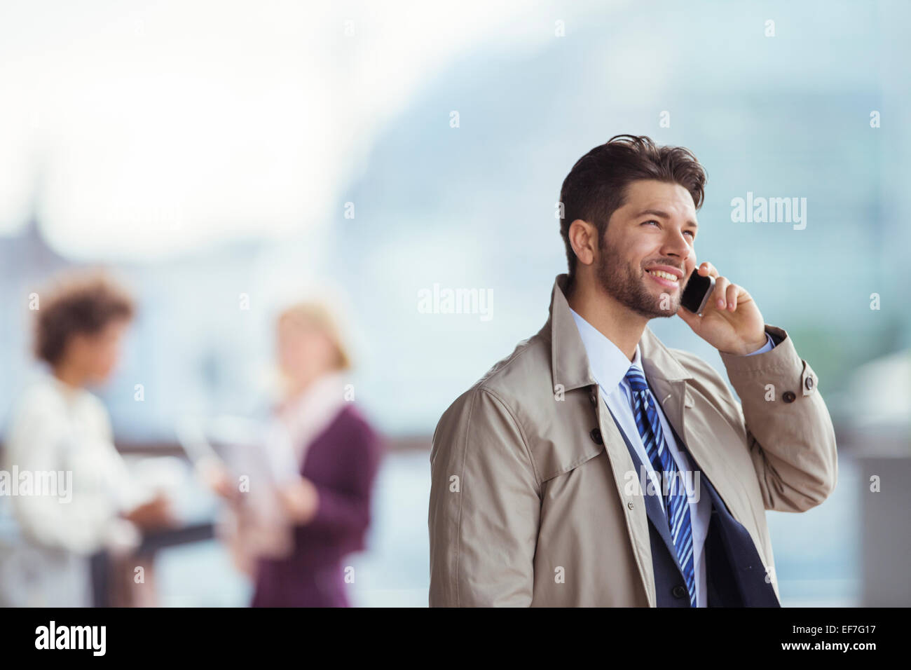 Businessman talking on cell phone outdoors Stock Photo