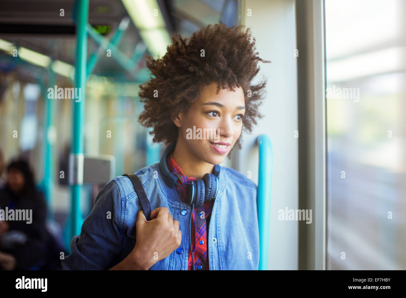 Woman looking out window of train Stock Photo