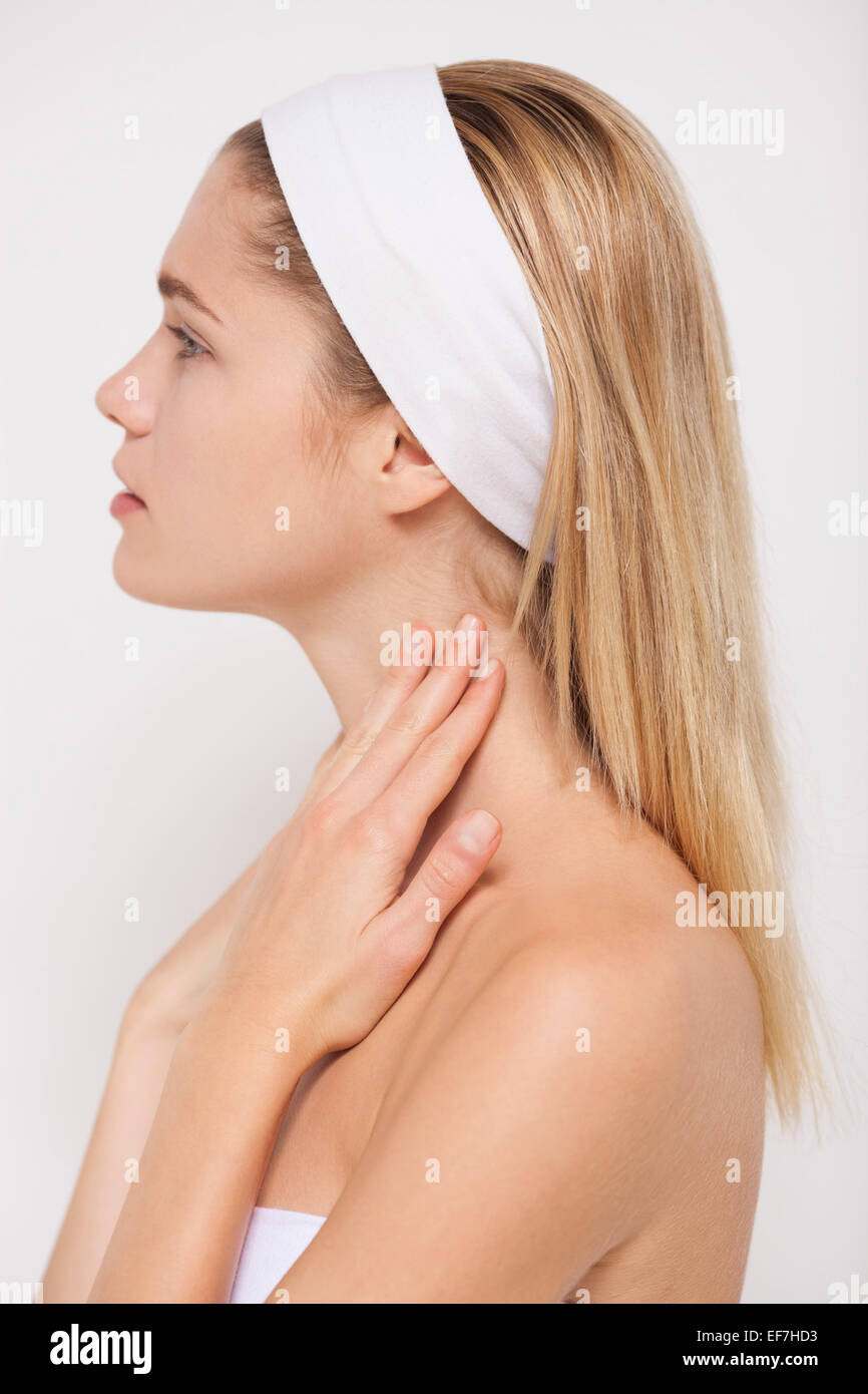 Beautiful woman applying moisturizer on her neck Stock Photo Alamy