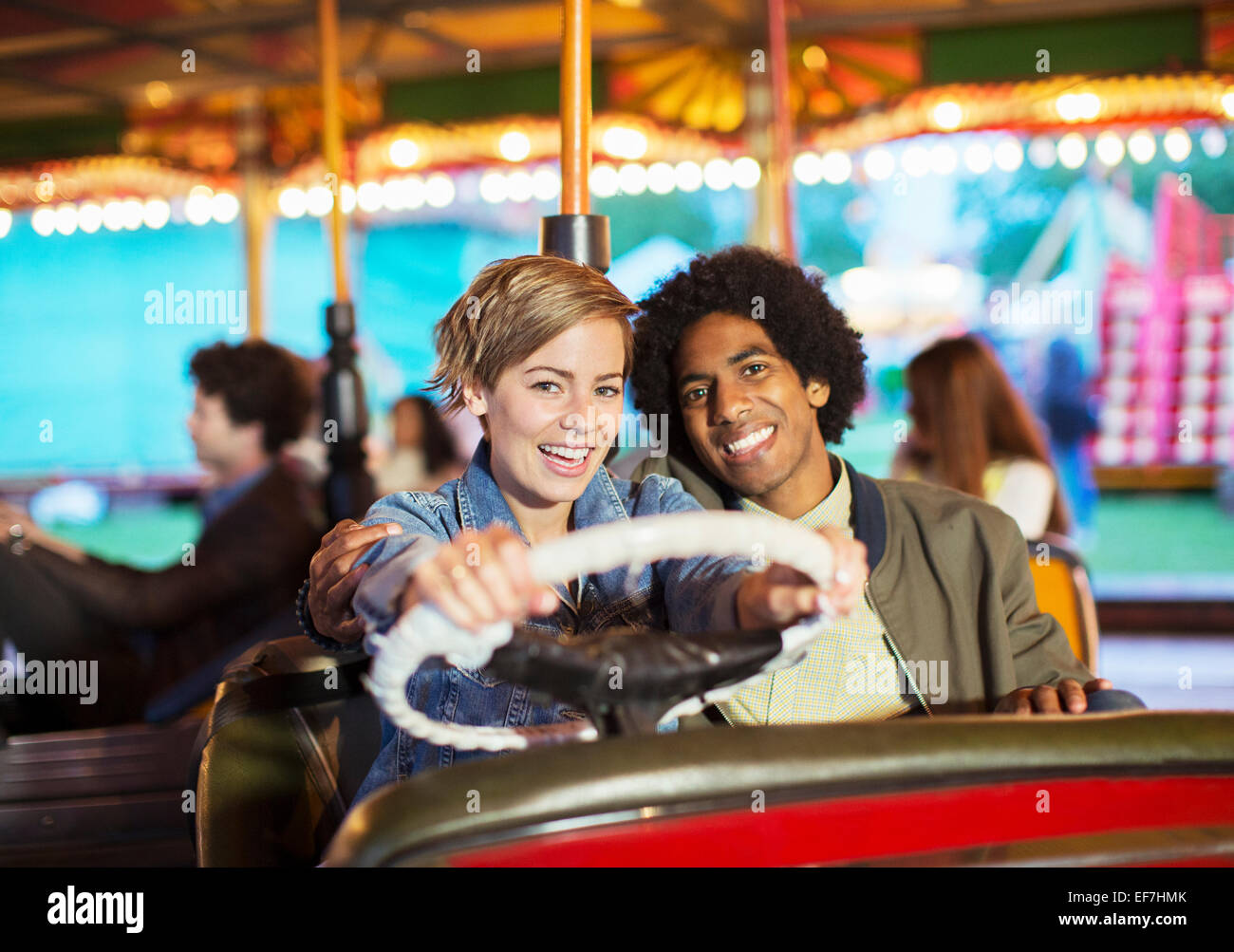 Young couple on bumper car ride in amusement park Stock Photo