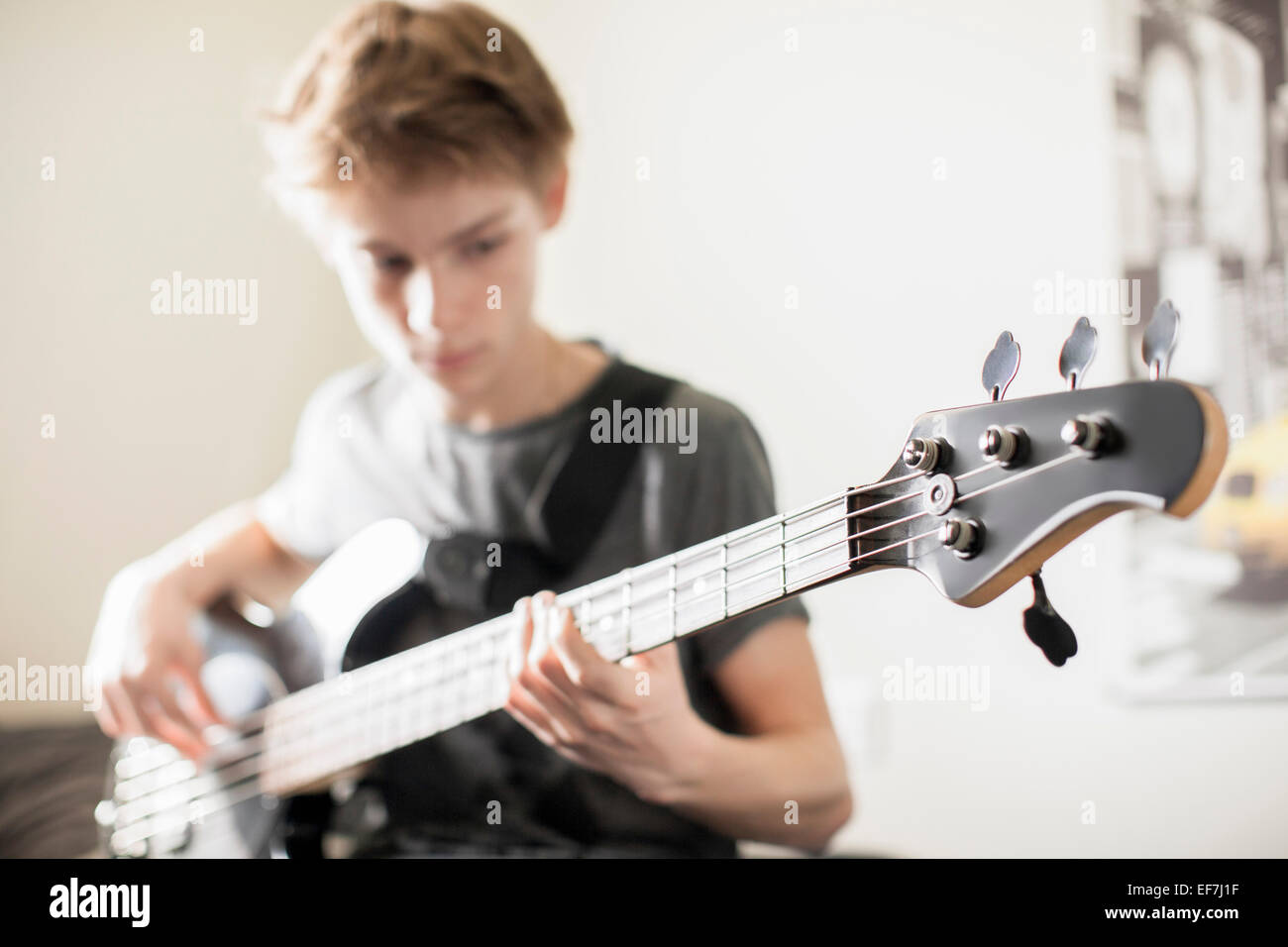 Teenage boy playing a guitar Stock Photo