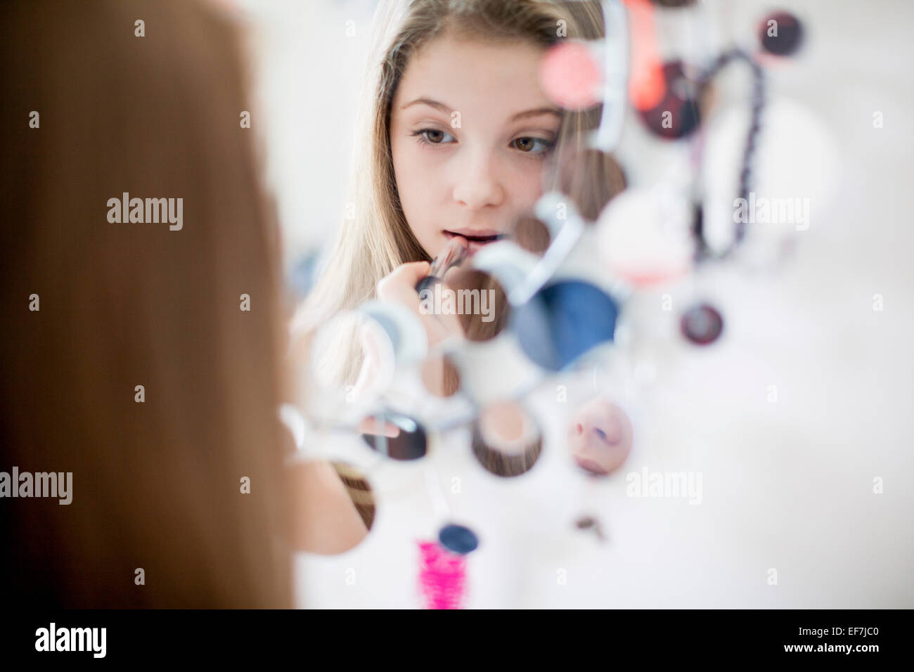 Girl applying lipstick on mirror Stock Photo Alamy
