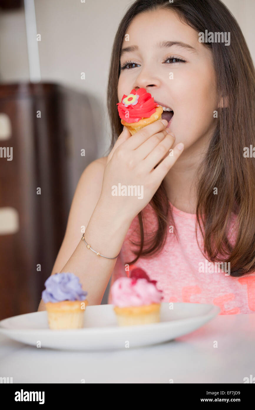 Happy girl eating cupcake Stock Photo Alamy