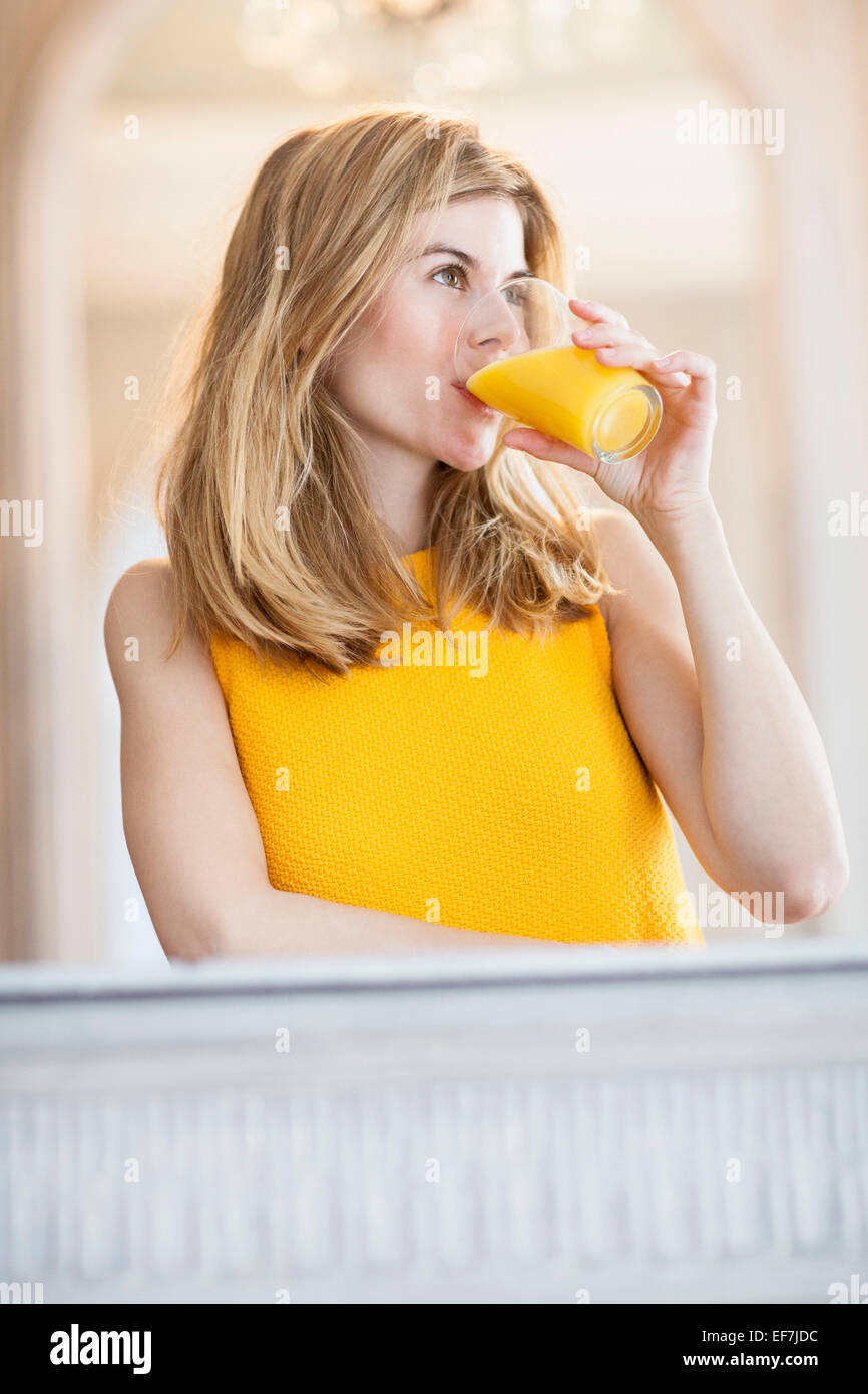 Woman drinking orange juice Stock Photo