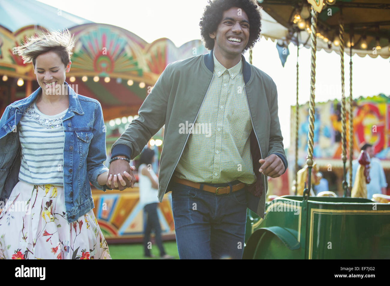 Young multiracial couple having fun in amusement park Stock Photo