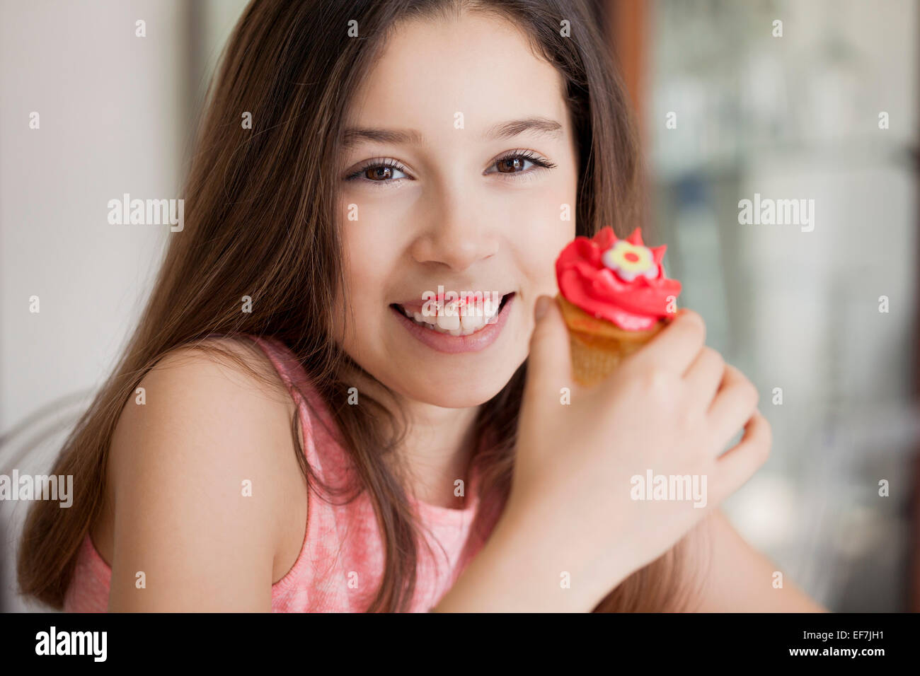 Happy girl eating cupcake Stock Photo Alamy