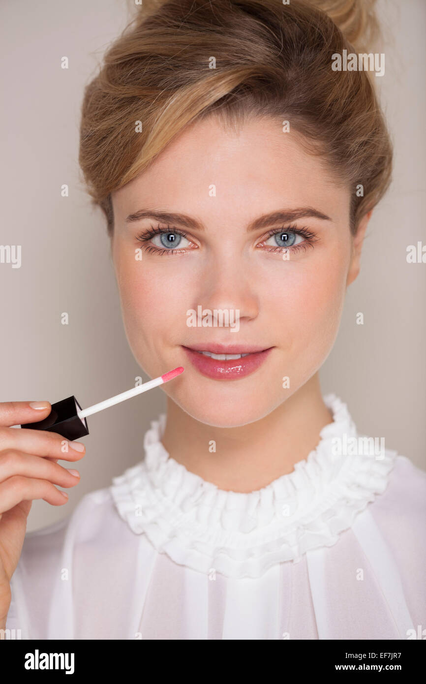 Portrait of beautiful woman applying lip gloss Stock Photo Alamy
