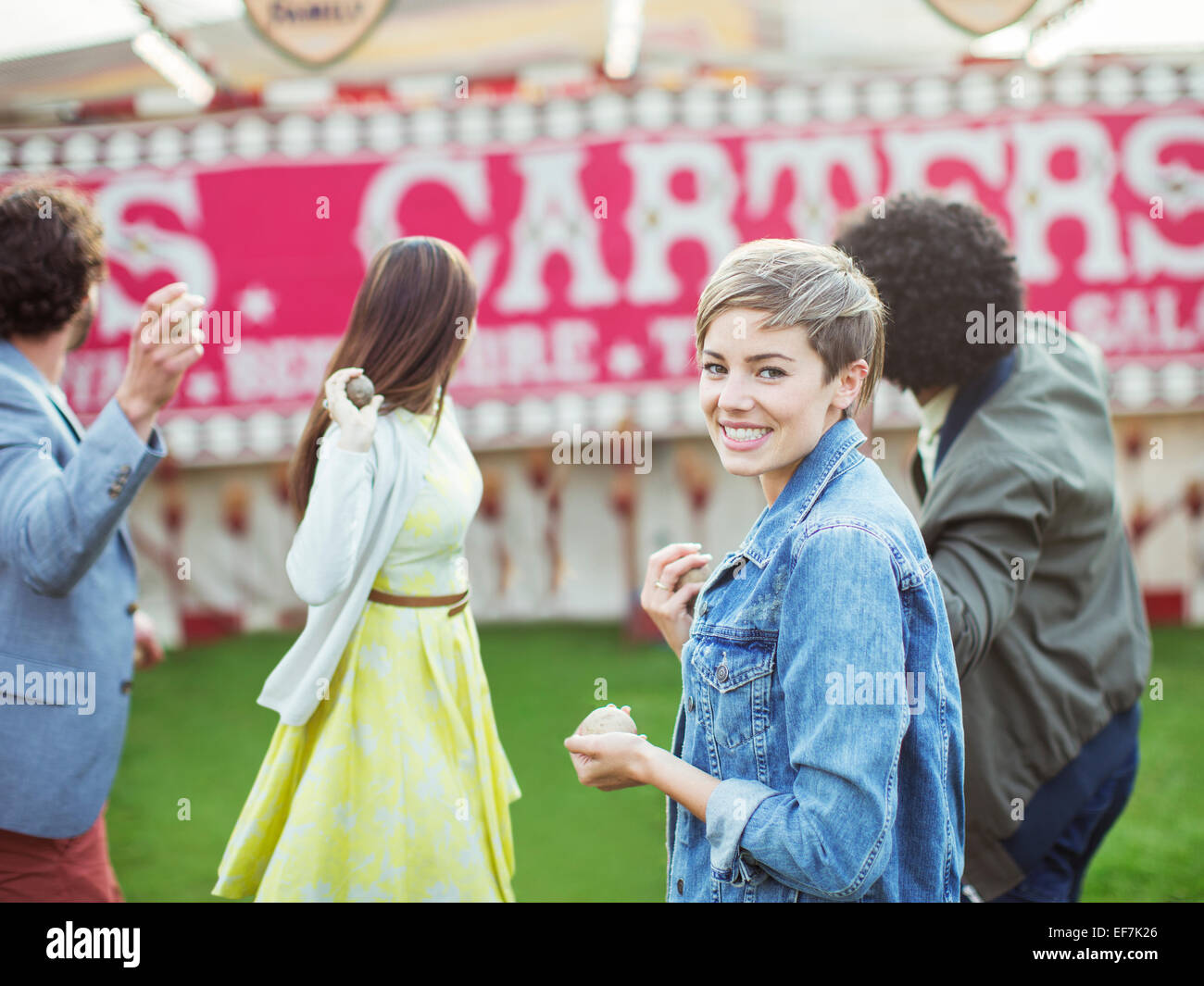 Group of friends playing game in amusement park Stock Photo