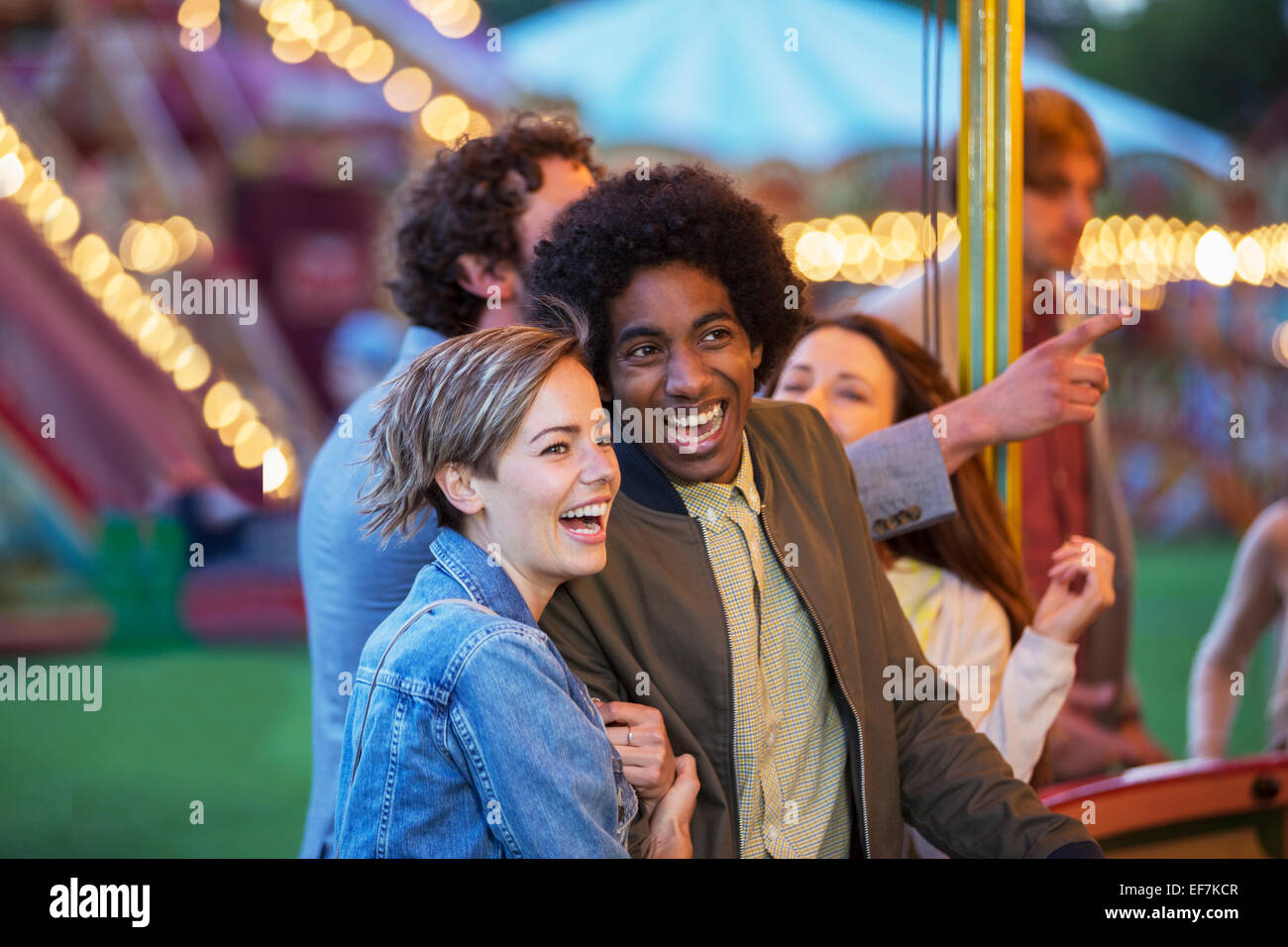 Young multiracial couple having fun in amusement park Stock Photo