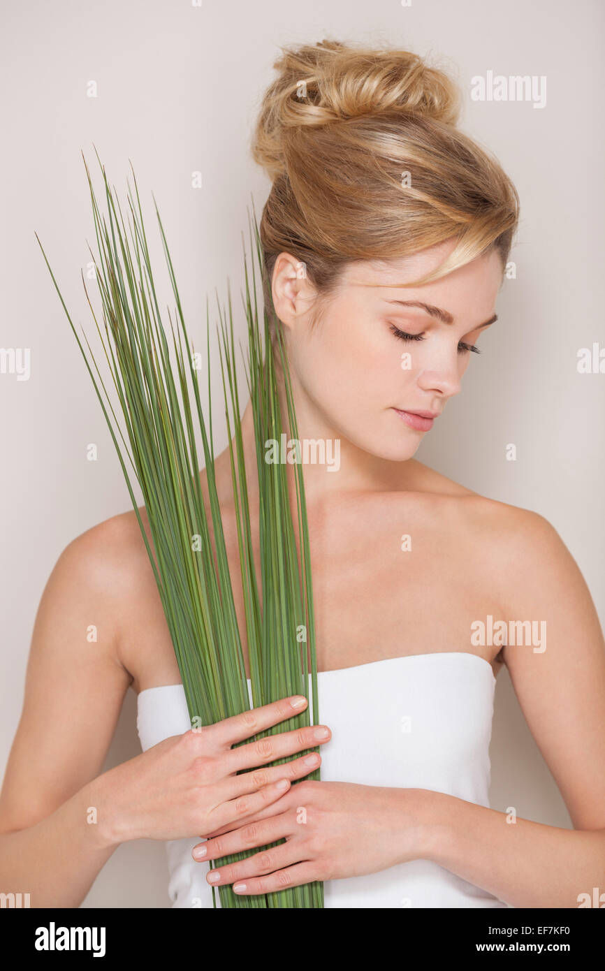 Beautiful woman holding wheatgrass Stock Photo