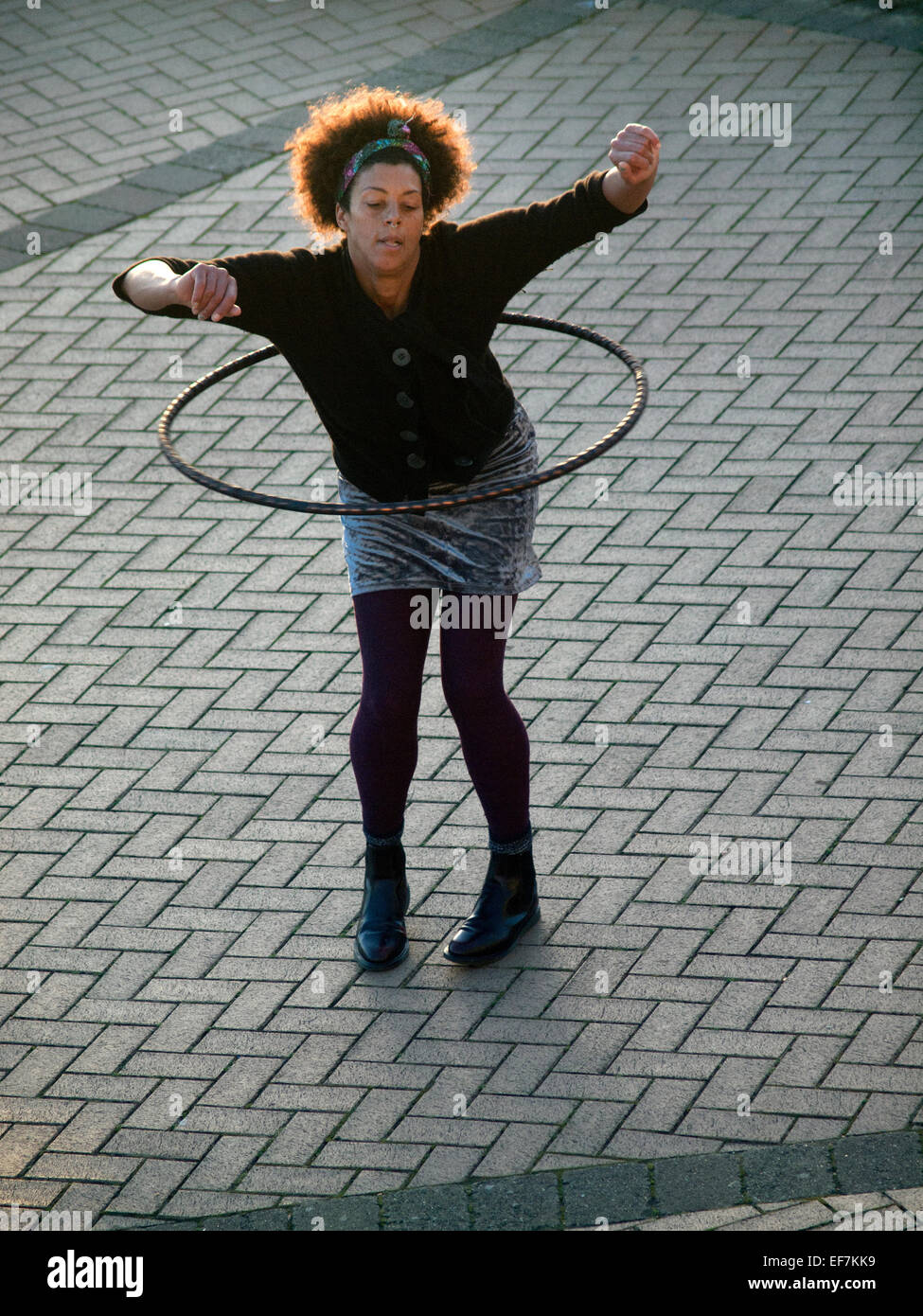 A girl dances with her hula hoop in Brighton Stock Photo - Alamy
