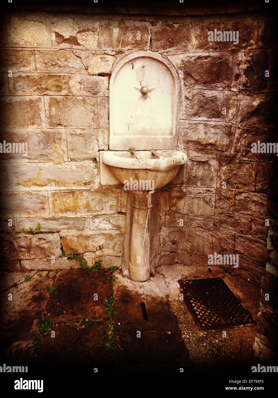 An old public fountain survives in the periphery of Trieste Stock Photo