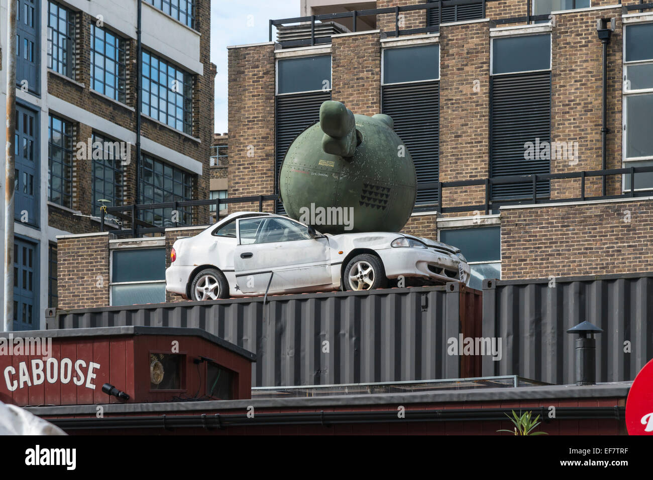 Modern art sculpture of a ball on top of a car in the Brick Lane area of central London. - EDITORIAL USE ONLY Stock Photo