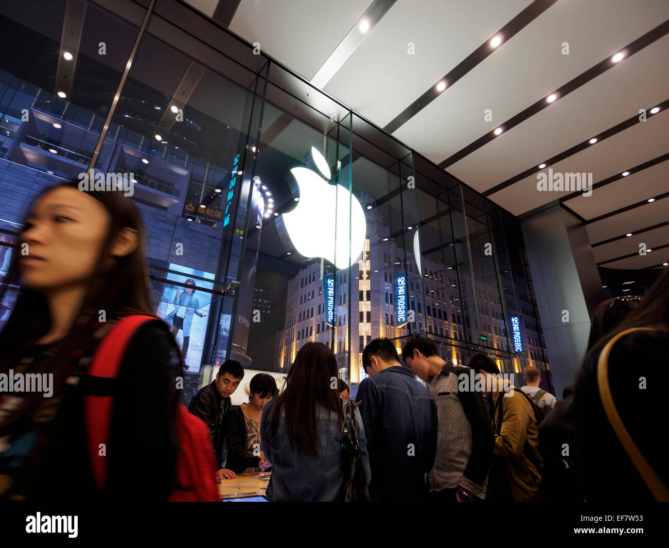 Costumers inside the Apple store located on Nanjing Road in Shanghai, China Stock Photo