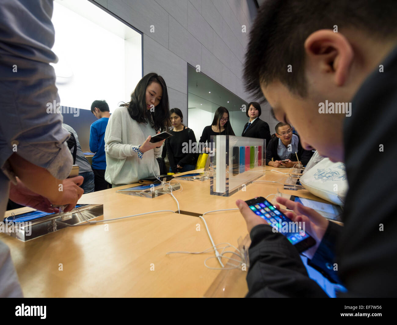 Costumers browsing Apple products at the Apple store located on Nanjing Road in Shanghai, China Stock Photo
