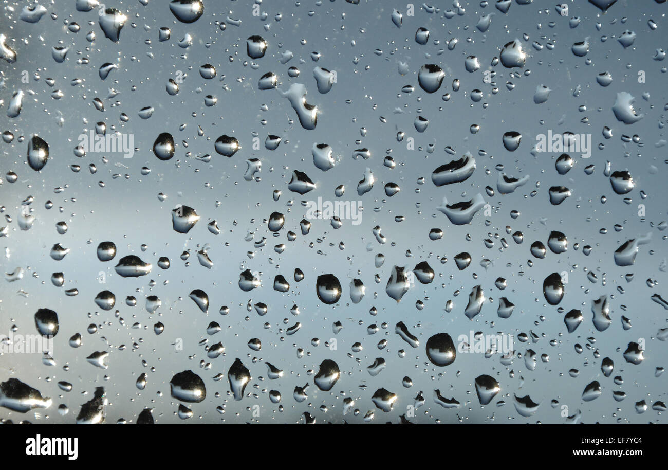 Brilliant spots of rain on the window glass Stock Photo