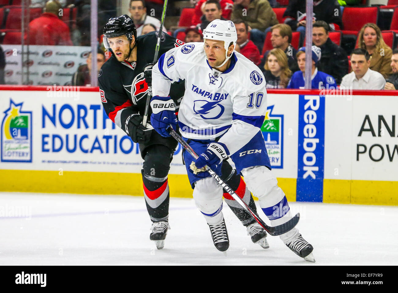 Raleigh, North Carolina, USA. 27th Jan, 2015. Tampa Bay Lightning left wing Brenden Morrow (10) and Carolina Hurricanes center Jay McClement (18) during the NHL game between the Tampa Bay Lightning and the Carolina Hurricanes at the PNC Arena.  The Carolina Hurricanes defeated the Tampa Bay Lightning 4-2. Credit:  Andy Martin Jr/Alamy Live News Stock Photo