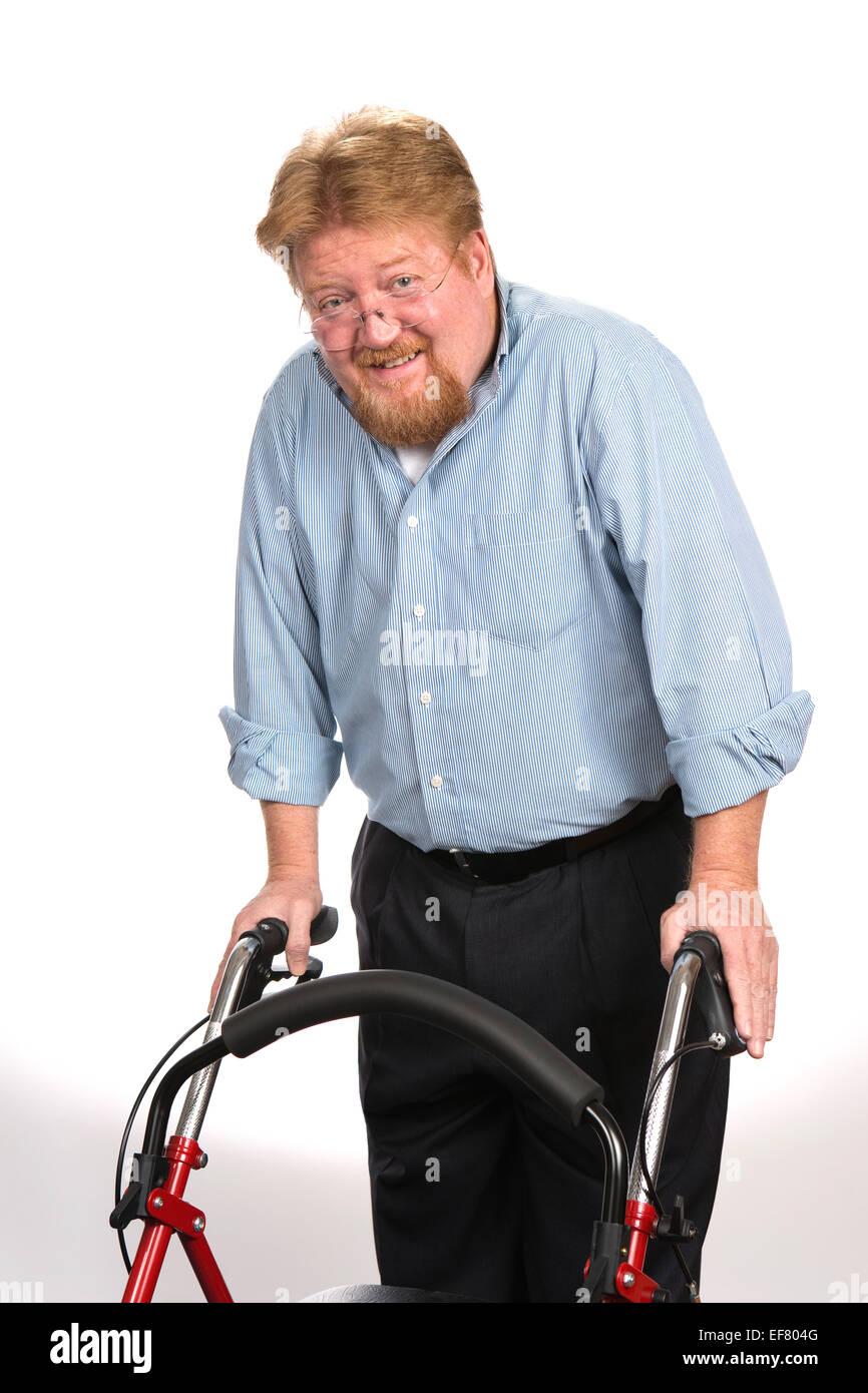 Happy and smiling disabled man uses a walker to maintain his balance. Stock Photo