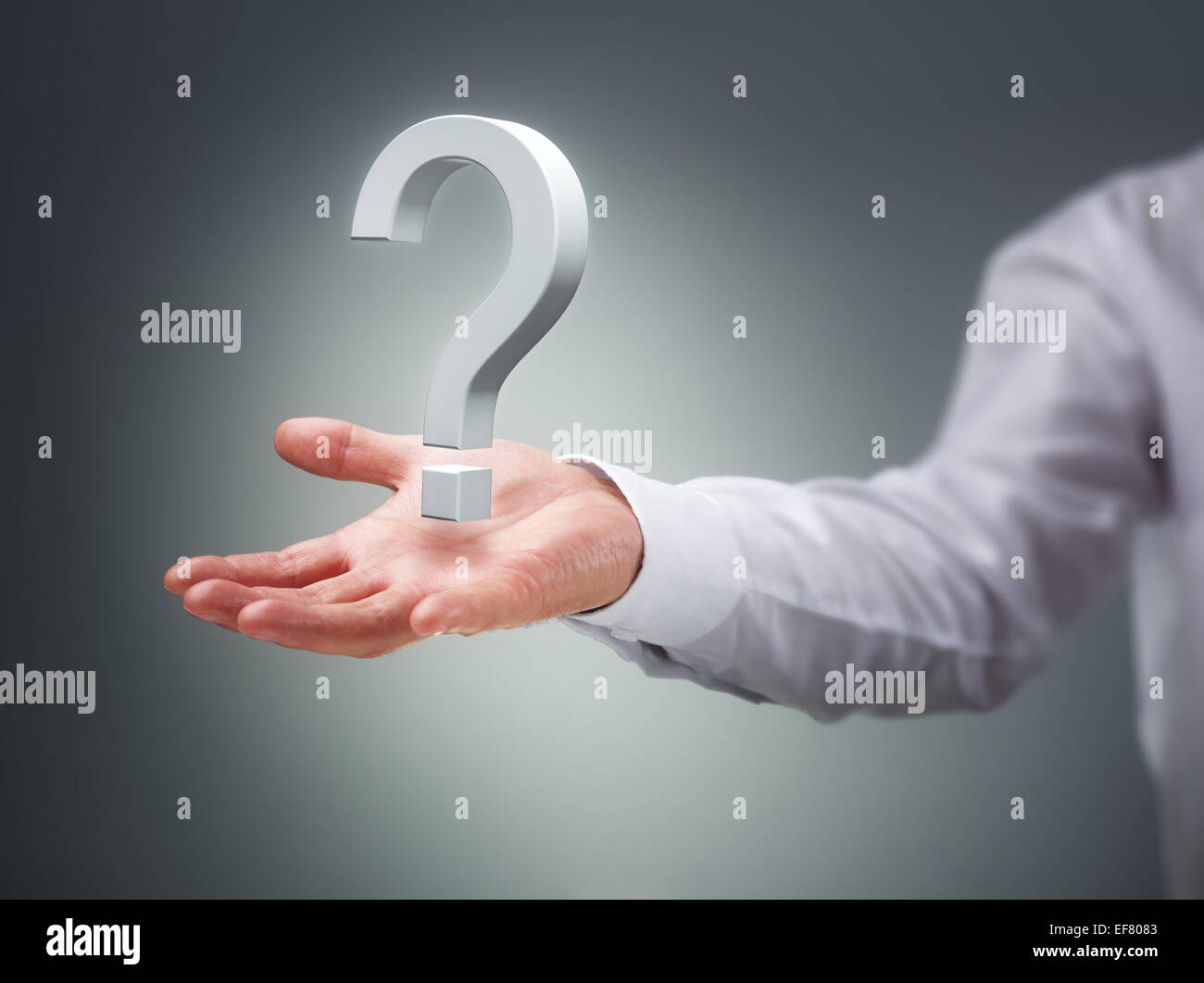 Businessman holding a virtual question mark concept for confusion, choice, searching or decisions Stock Photo