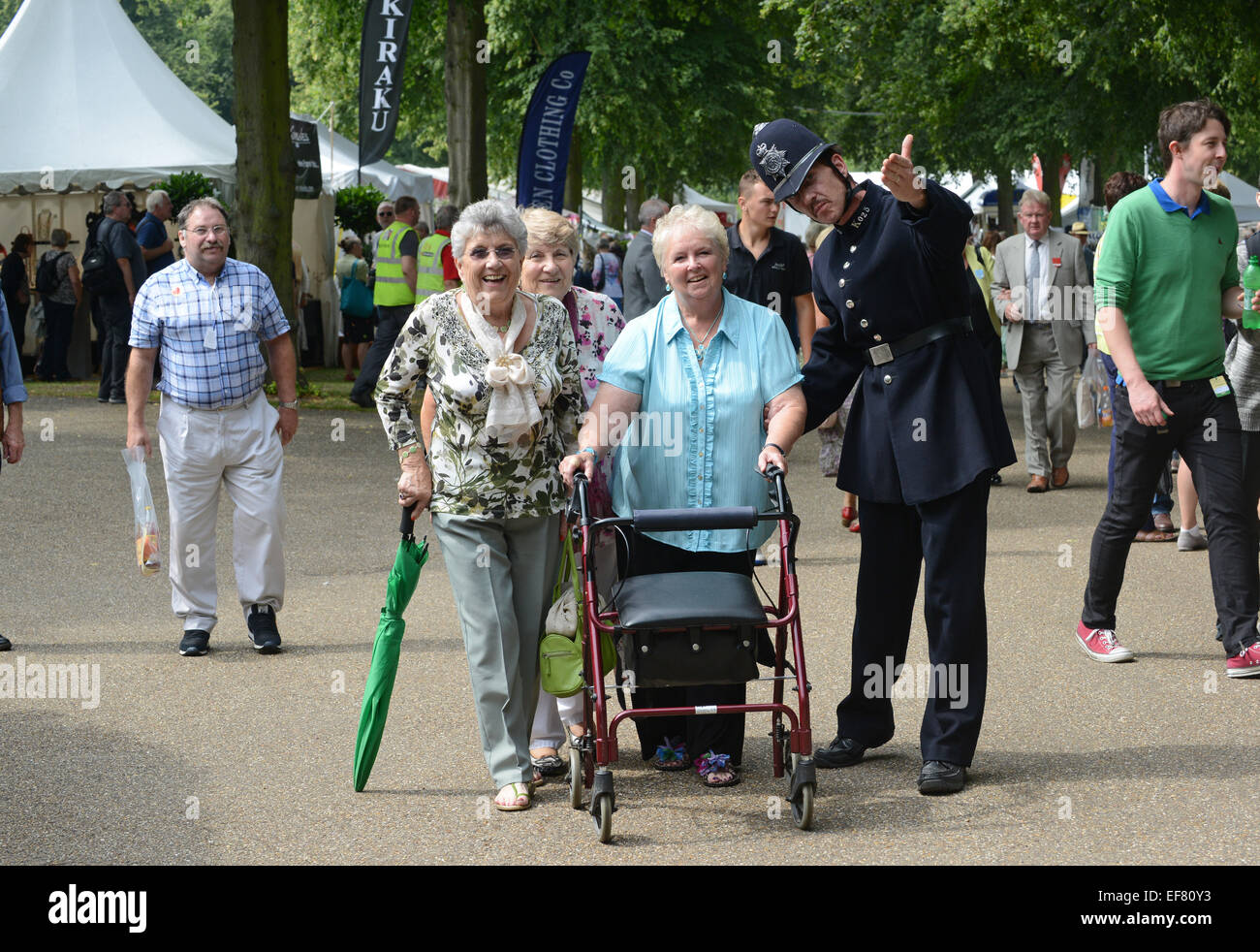 Police officer policeman in victorian period costume helping visitors at Shrewsbury Flower Show 2014 Stock Photo