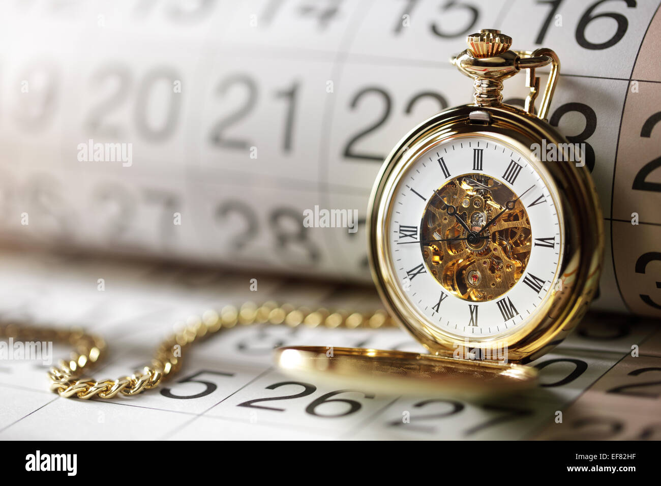 Gold pocket watch and calendar Stock Photo