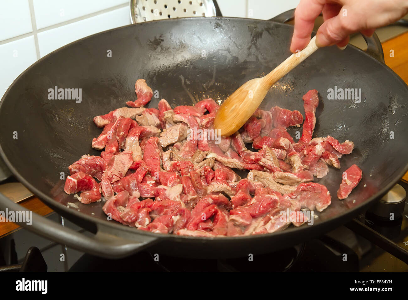 Fry beef strips in a wok Stock Photo Alamy