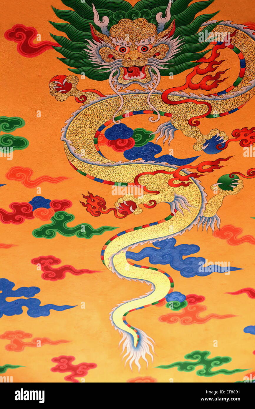 Buddhist drawing-decoration on tan color painted wall showing traditional religious symbol -naga- in an inner hall of the T.T.Y. Stock Photo