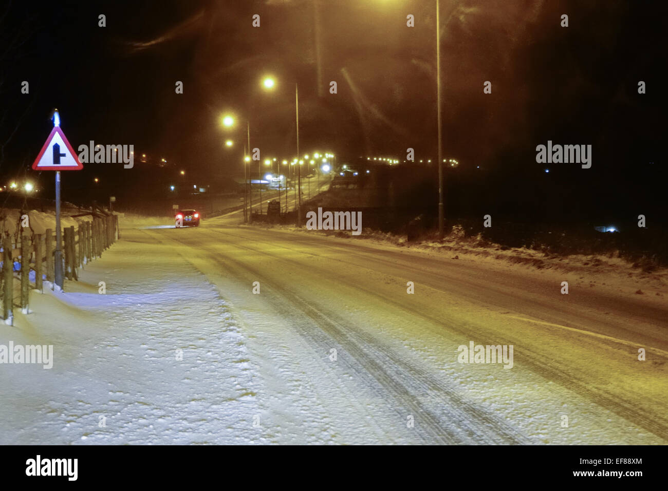 Blowing snow on roads in Queensbury, West Yorkshire at night Stock