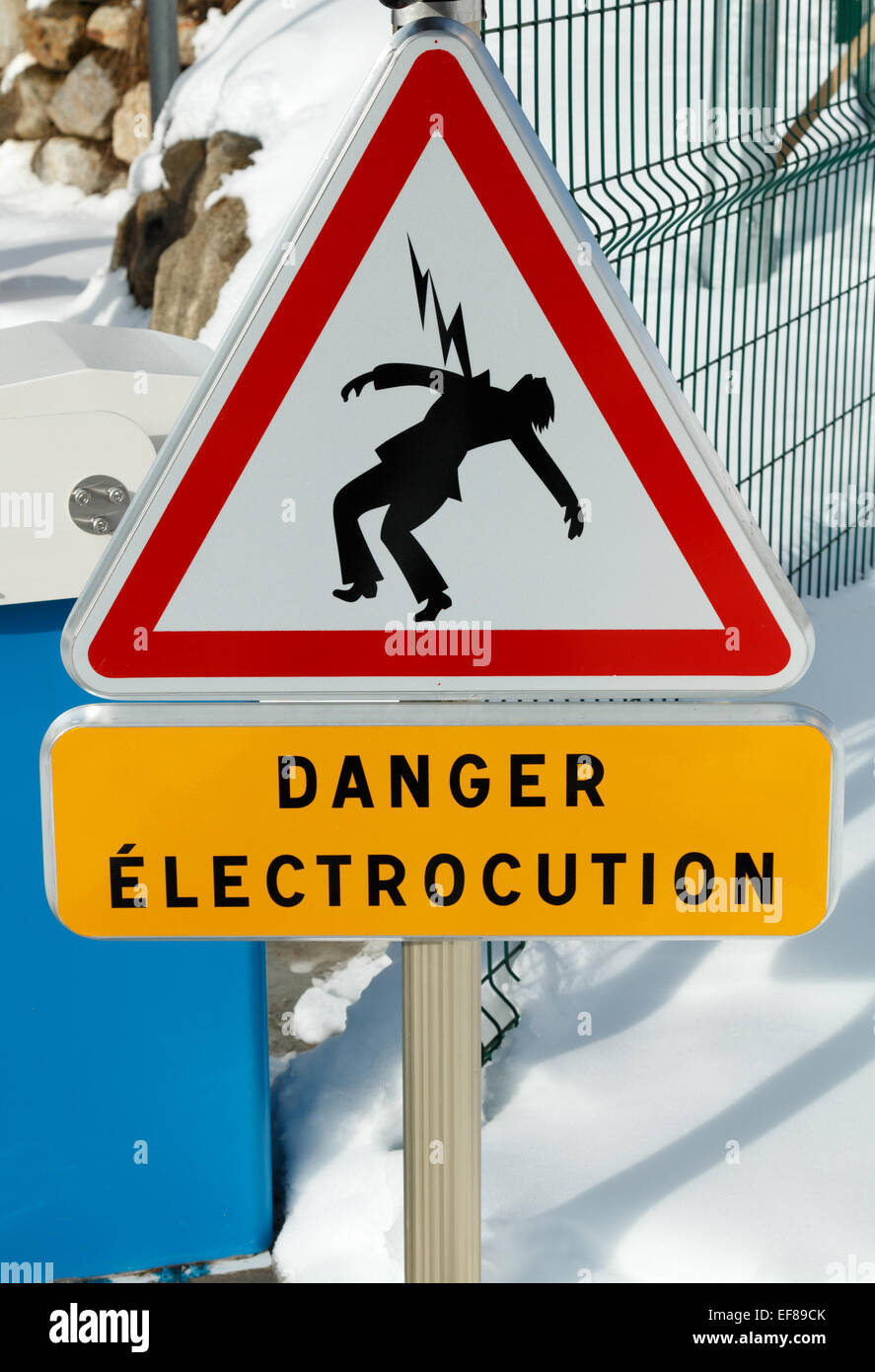 Danger sign warning of the risk of electrocution from the live rail on the French railway network.  It warns of the danger of electric shock. Stock Photo