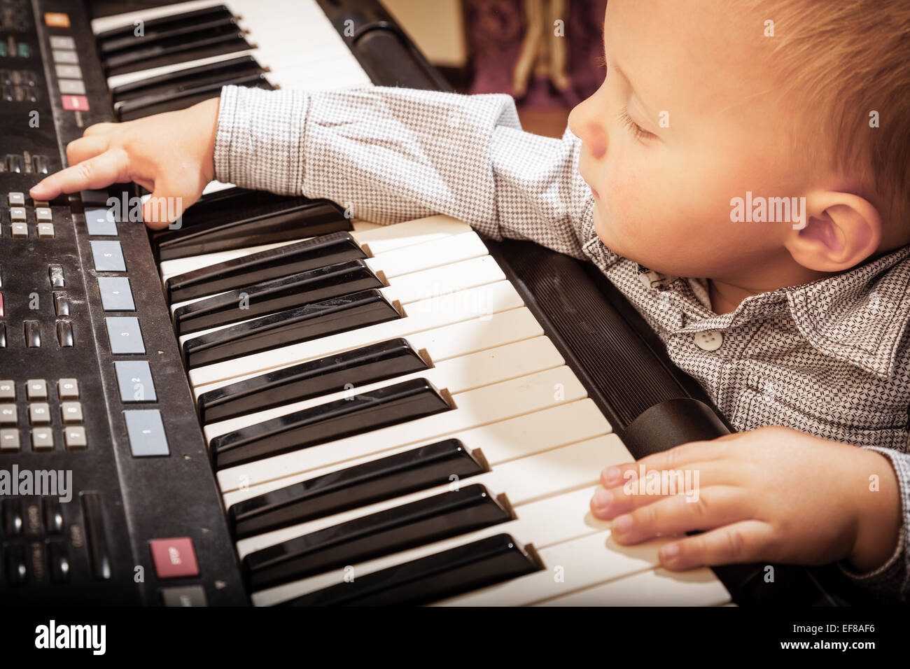 Happy childhood and music. Little boy child kid playing on the black