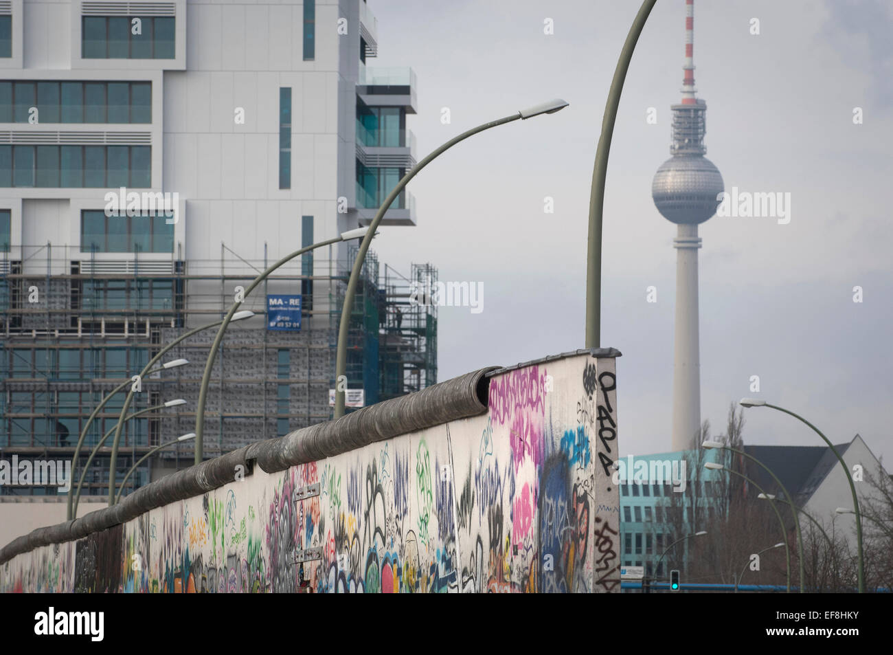 Berlin's TV tower viewed from what remains of the Berlin Wall at the East Side Gallery,Mühlenstraße in Friedrichshain-Kreuzberg. Stock Photo