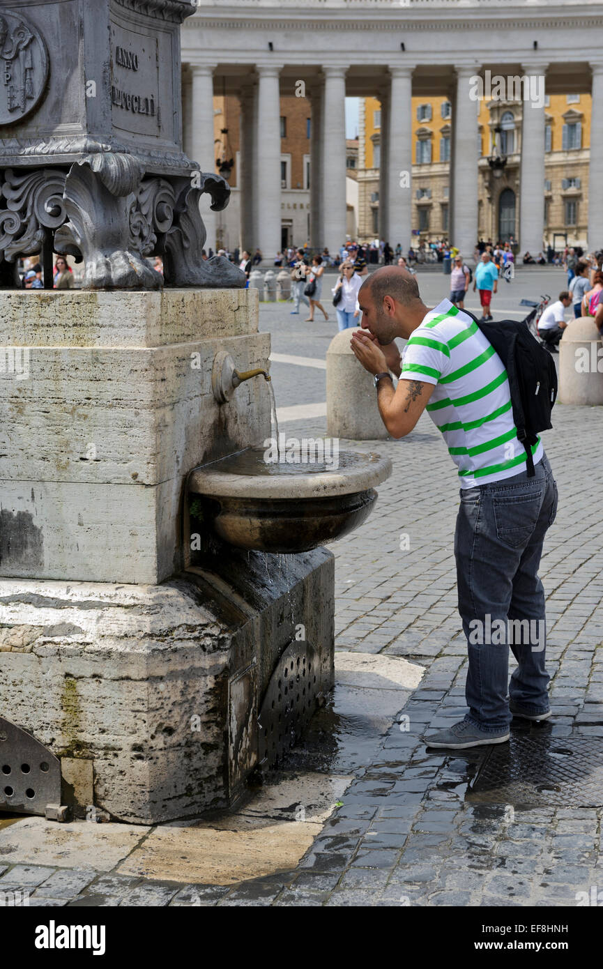 A man drinking from a water fountain in St Peter's Square, Vatican City