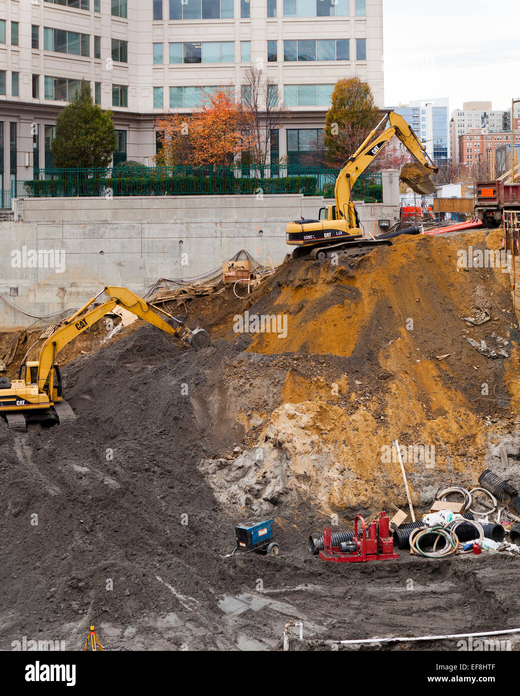 Excavators digging foundation at construction site - USA Stock Photo