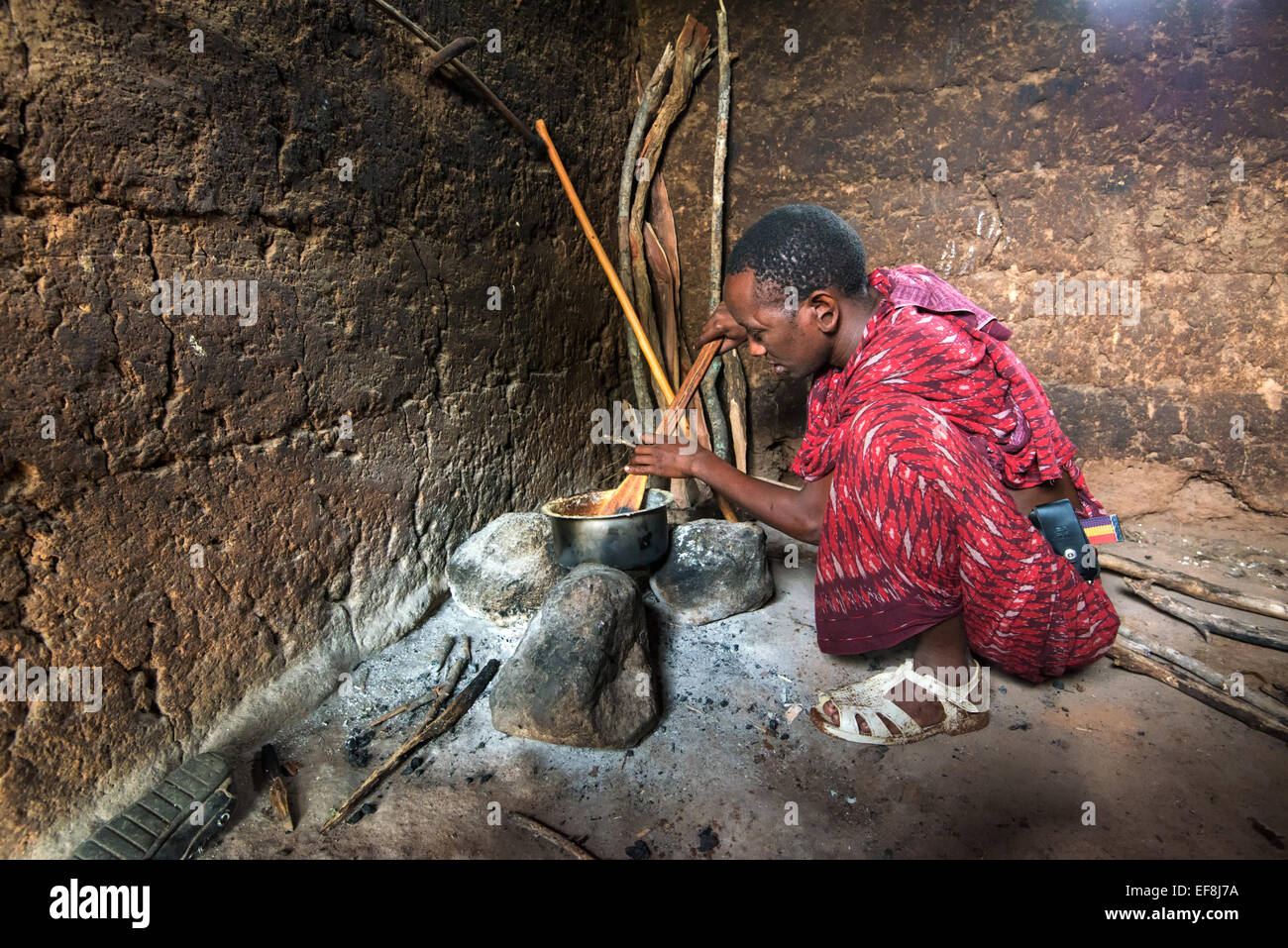 Masai man cooking Stock Photo