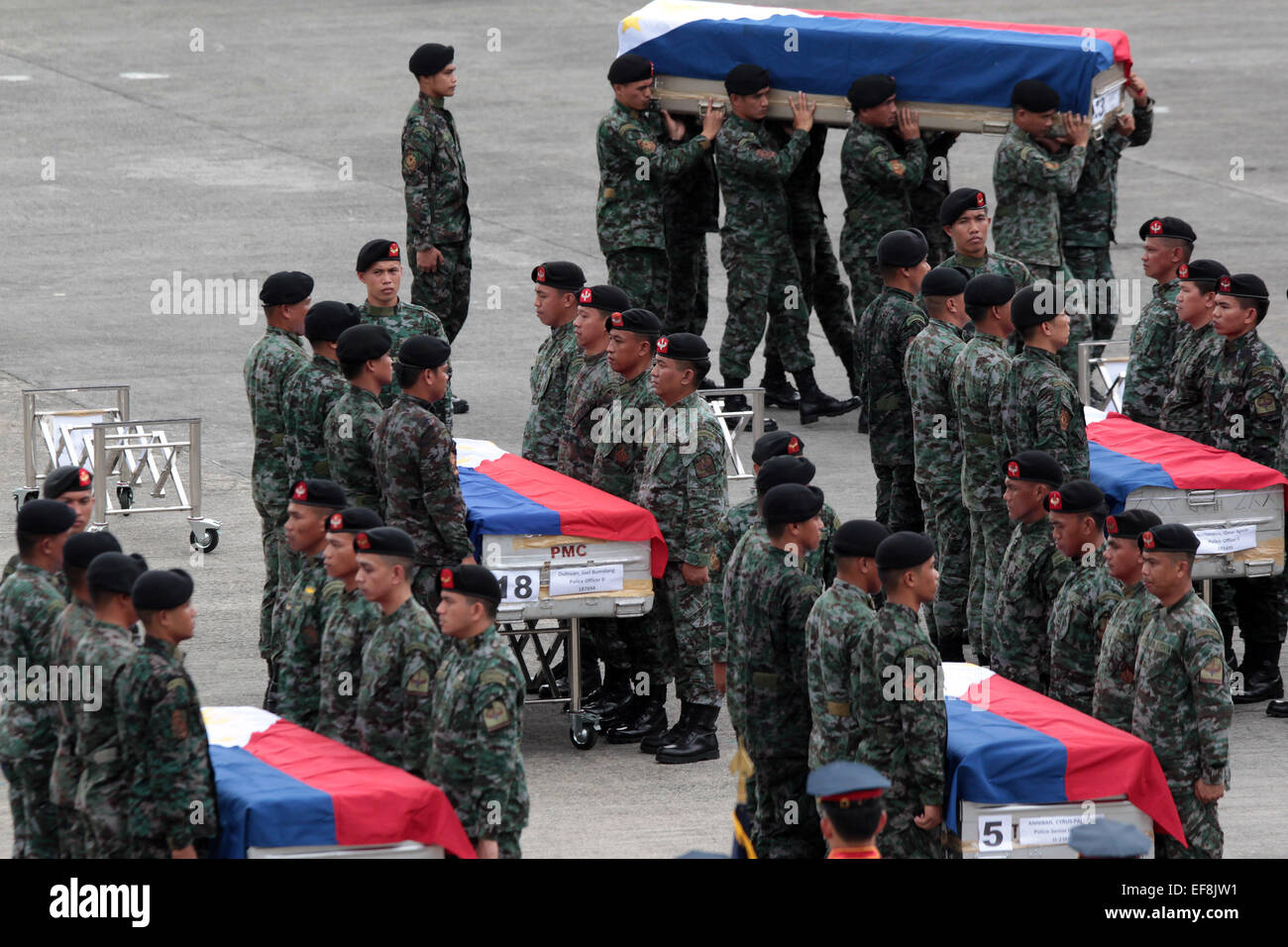 Pasay City, Philippines. 29th Jan, 2015. Members of the Philippine National Police Special Action Force (PNP-SAF) carry the caskets of their fallen comrades at the Villamor Air Base in Pasay City, the Philippines, Jan. 29, 2015. Forty-four members of the PNP-SAF were killed allegedly by Moro Islamic Liberation Front and Bangsamoro Islamic Freedom Fighters members on Jan. 25 in Mamasapano, Maguindanao. Credit:  Rouelle Umali/Xinhua/Alamy Live News Stock Photo