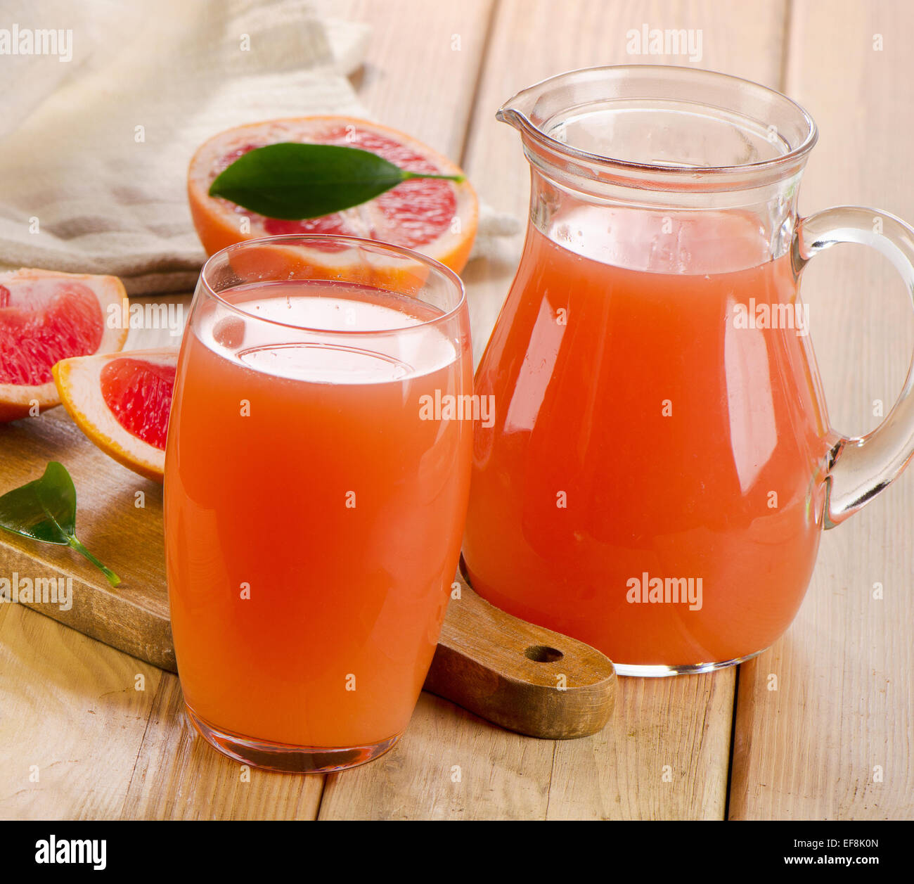 Grapefruit juice and  grapefruits on a wooden table. Selective focus Stock Photo
