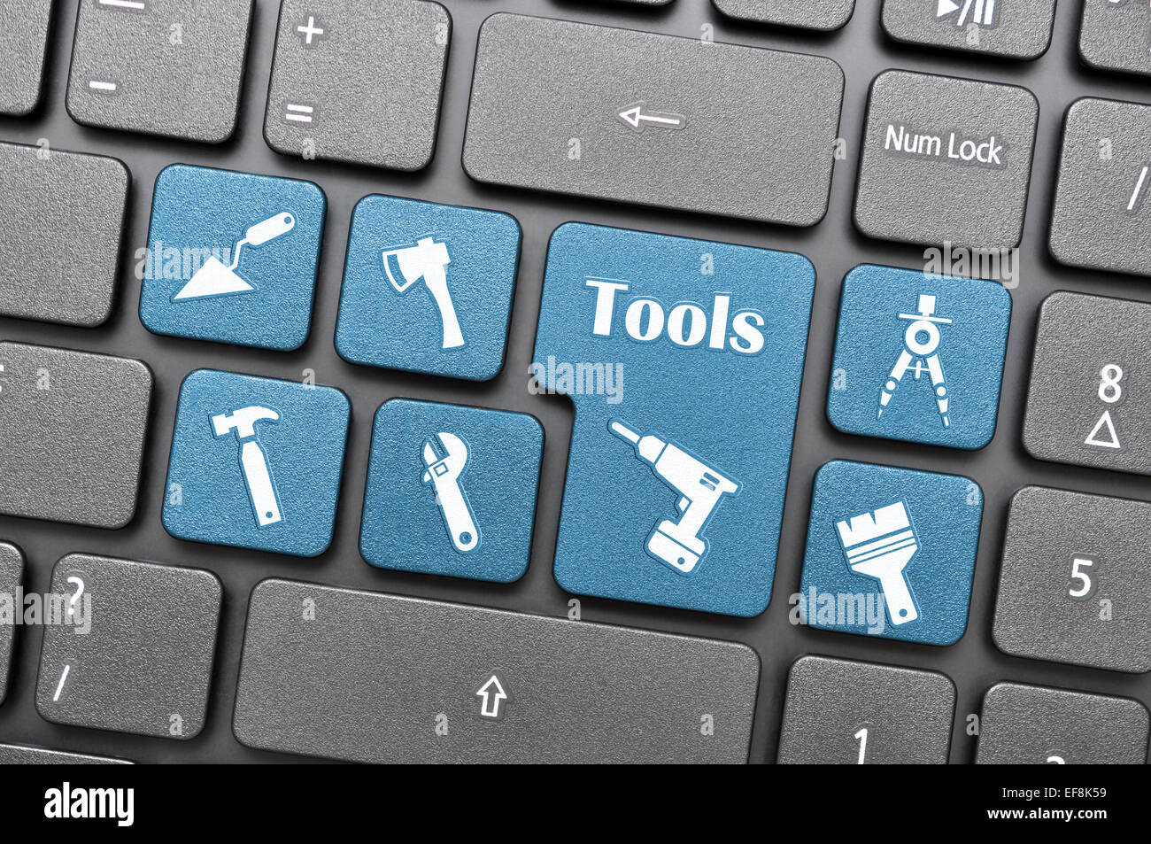 Blue tools key on keyboard Stock Photo Alamy